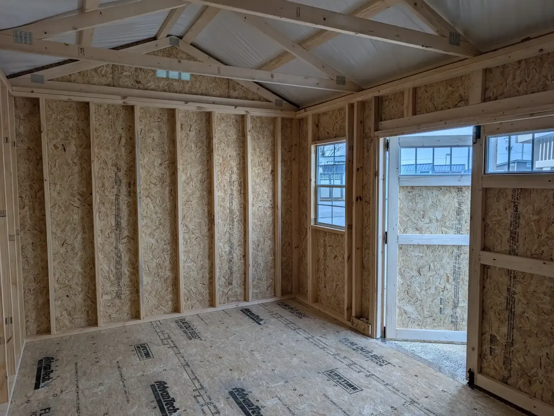 inside a garden shed looking at the double doors with transom windows