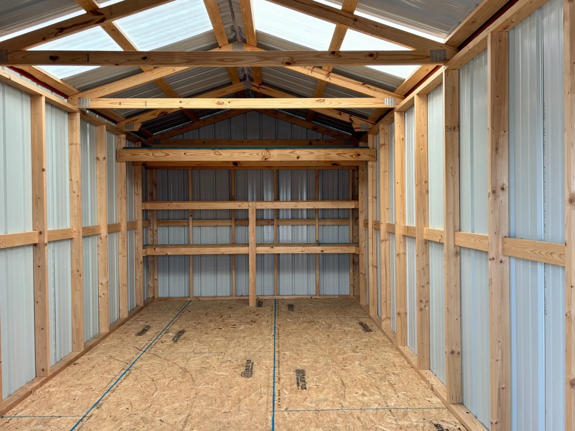 inside a metal shed with double shelves and skylights