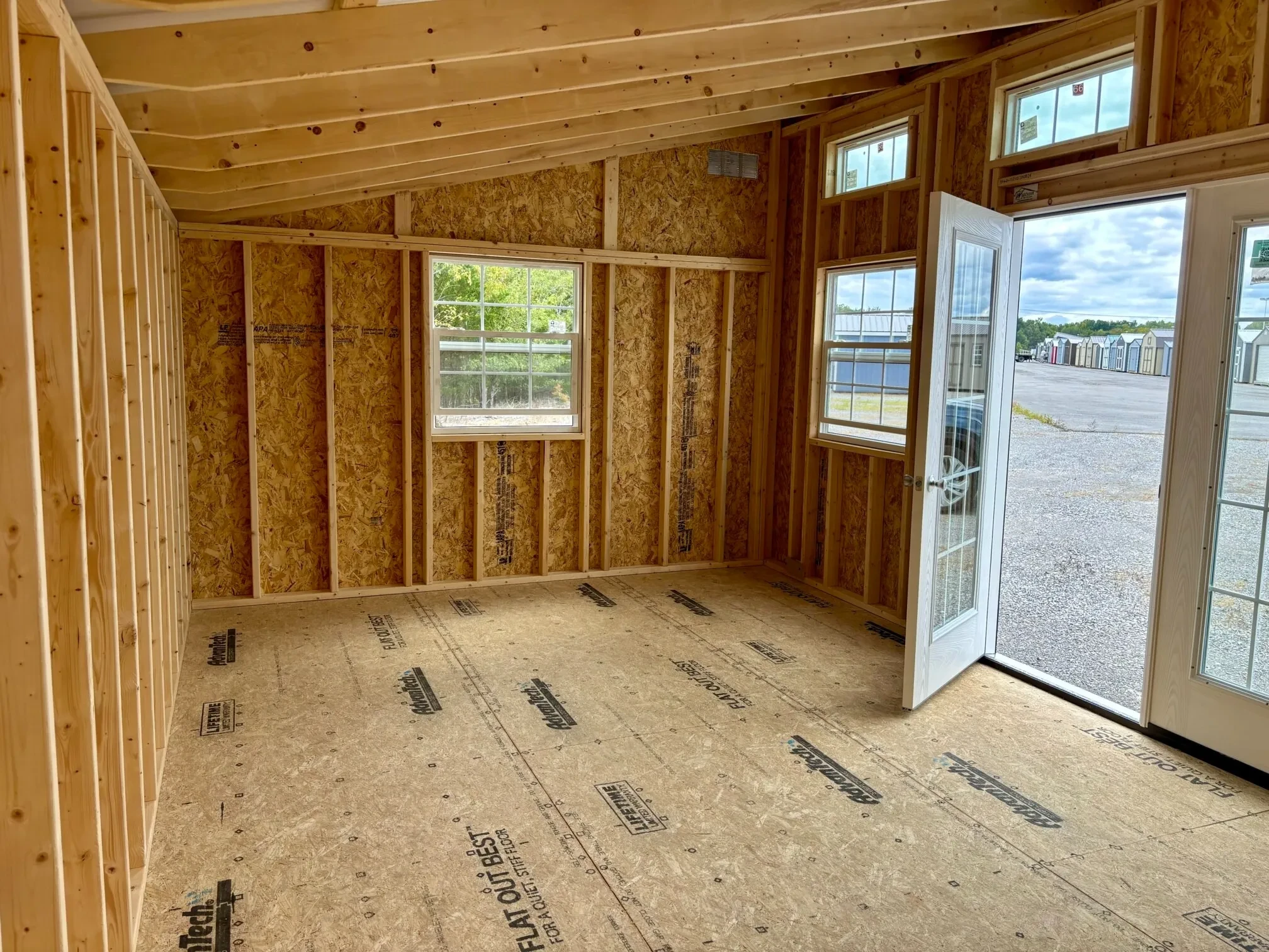 inside a studio shed looking at the glass door that is open