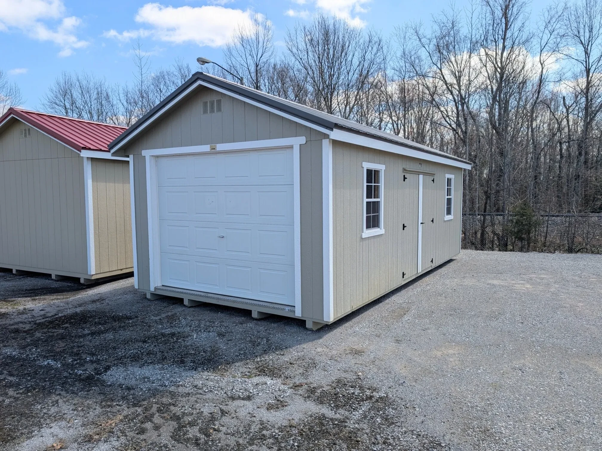 age shed with double doors, windows, and a garage door