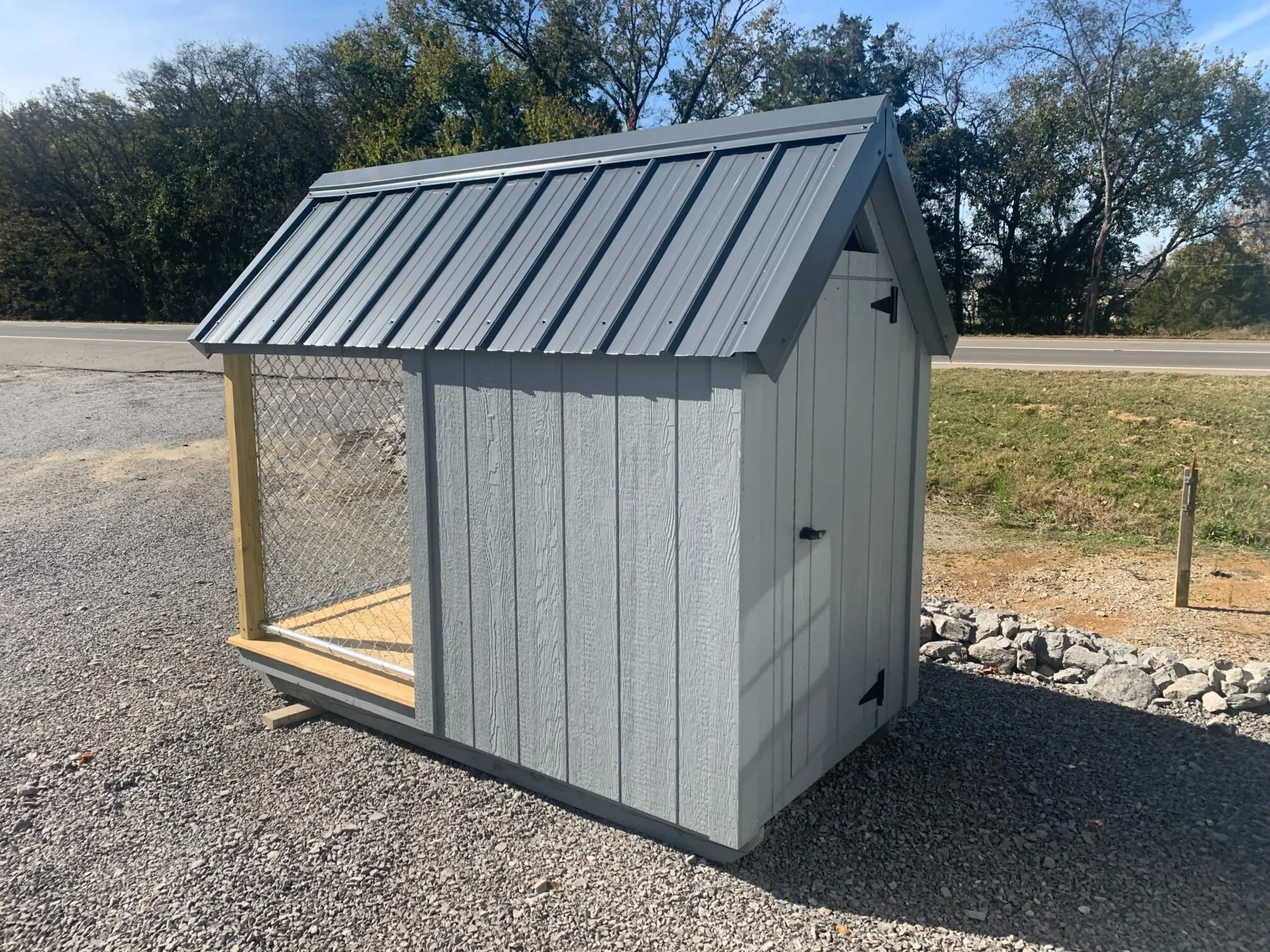 a gray dog house with a gray metal roof