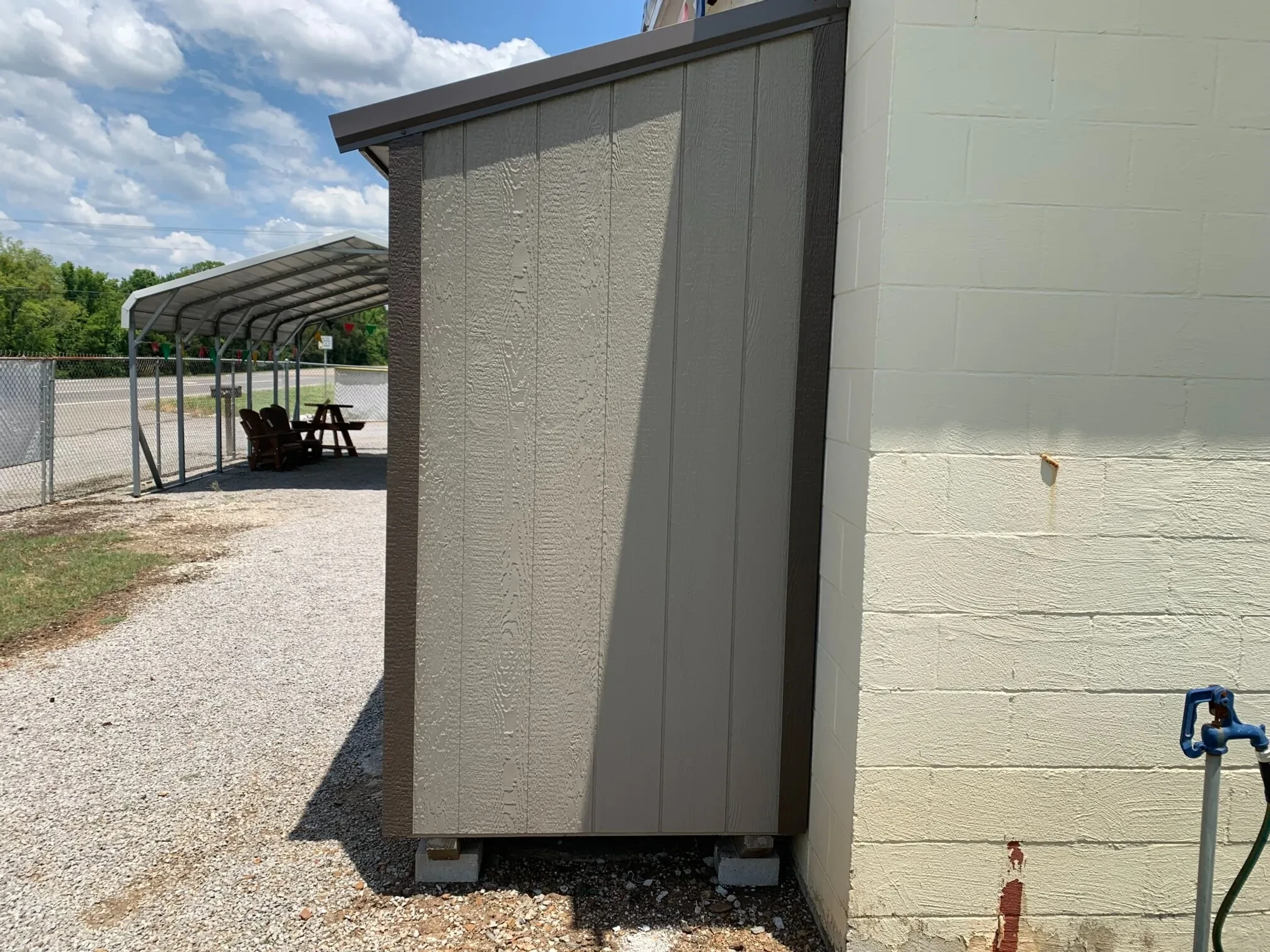the side of a wood leanto style shed