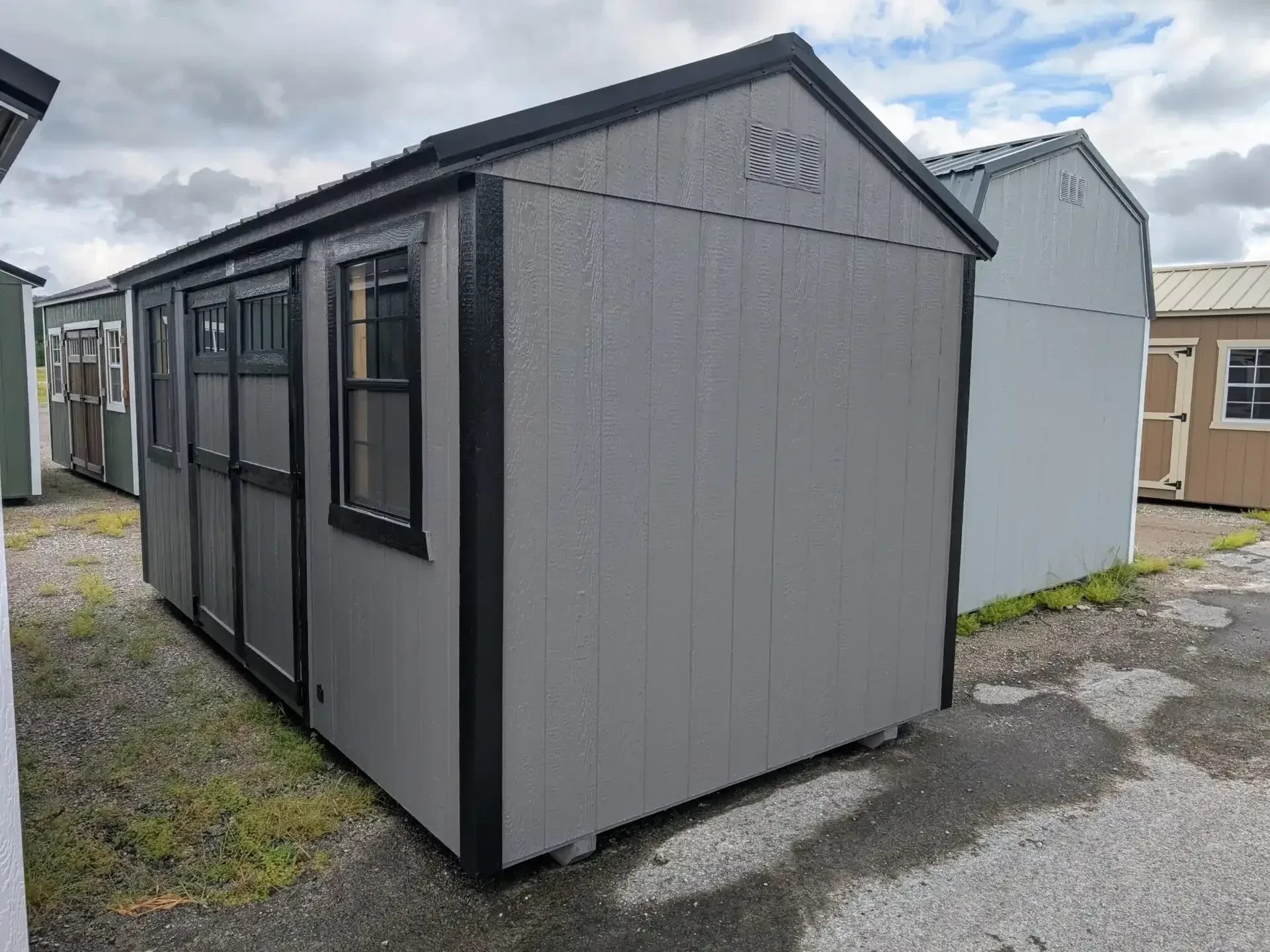 garden shed with black trim and two windows