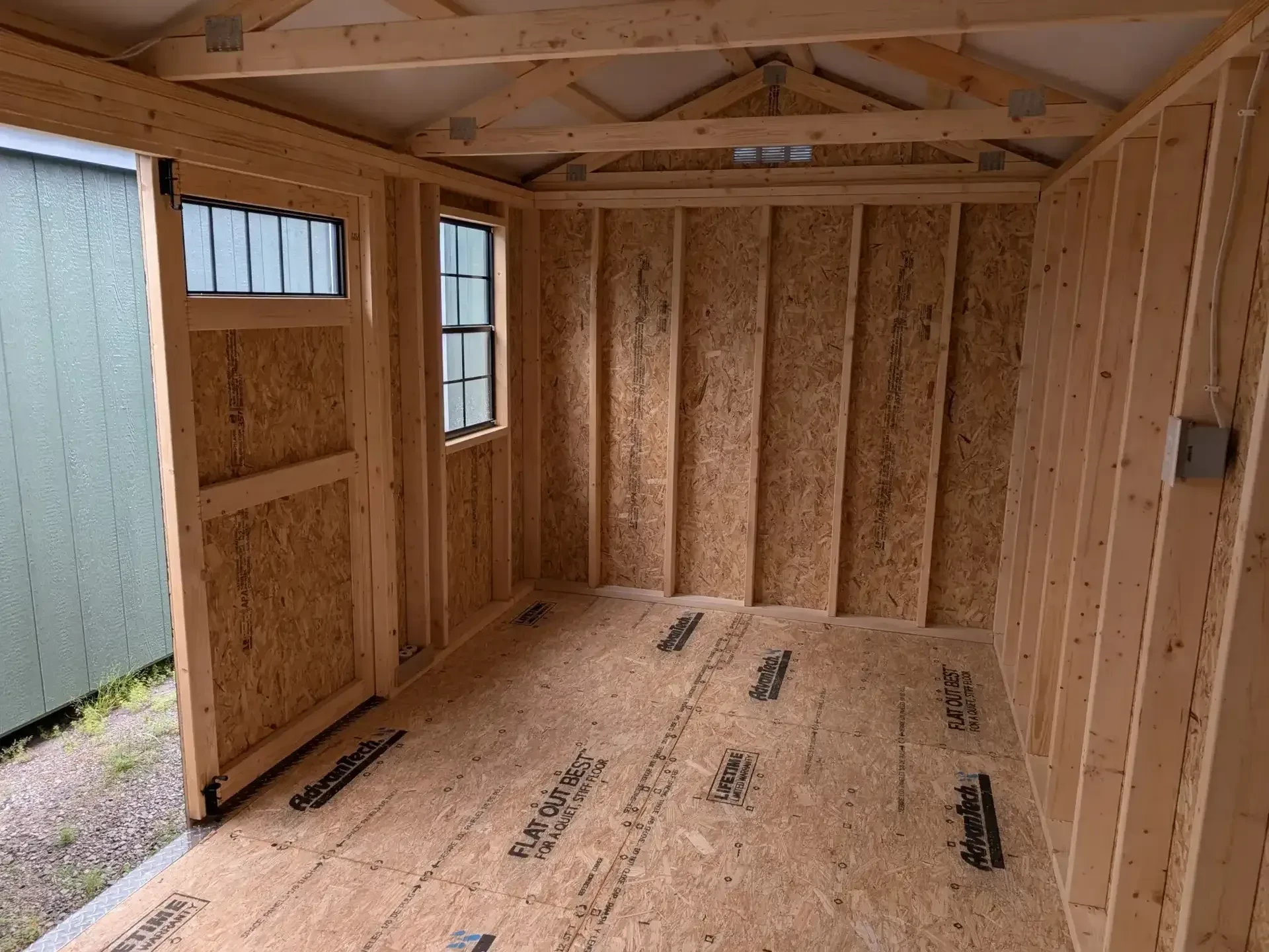 inside a wood garden shed with transom windows and 2x3 windows
