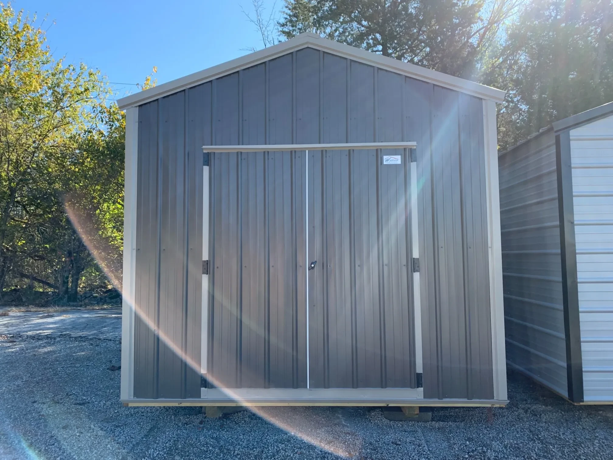 a bronze colored metal shed with double doors