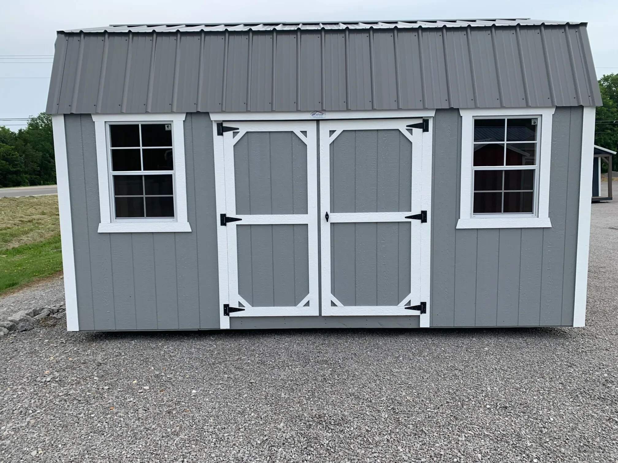 a wood side lofted barn with two 2x3 windows