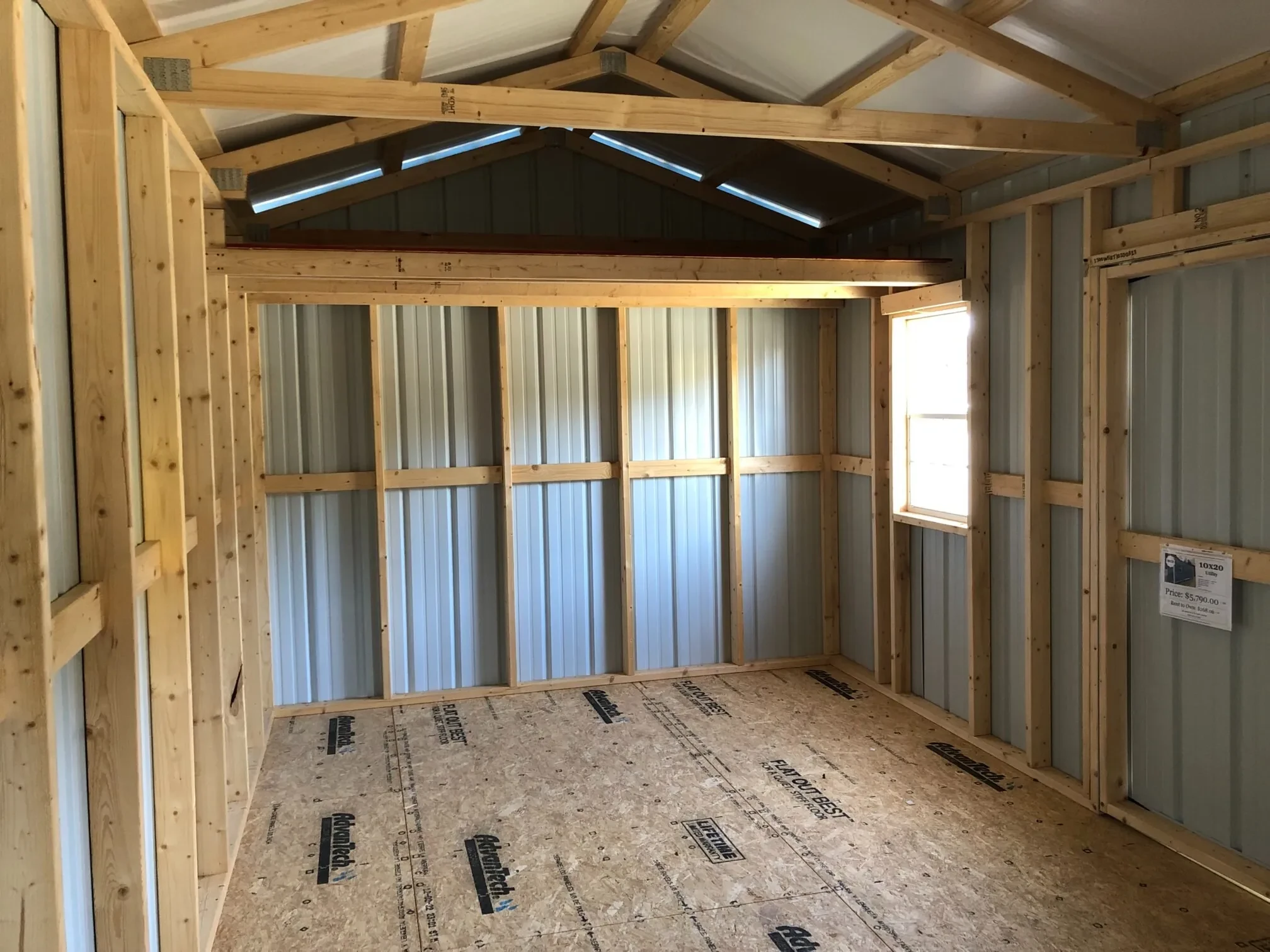 the right side interior of a metal shed with a loft