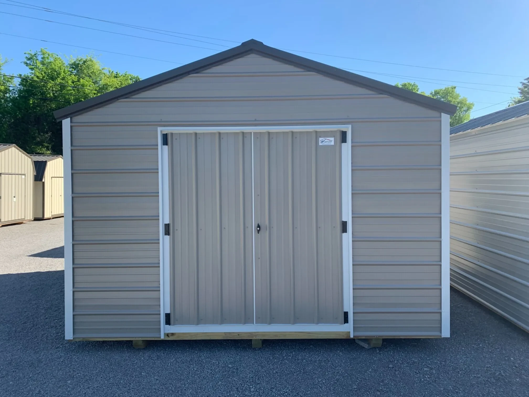 a 12' wide metal shed with horizontal metal on the siding and vertical metal on the doors