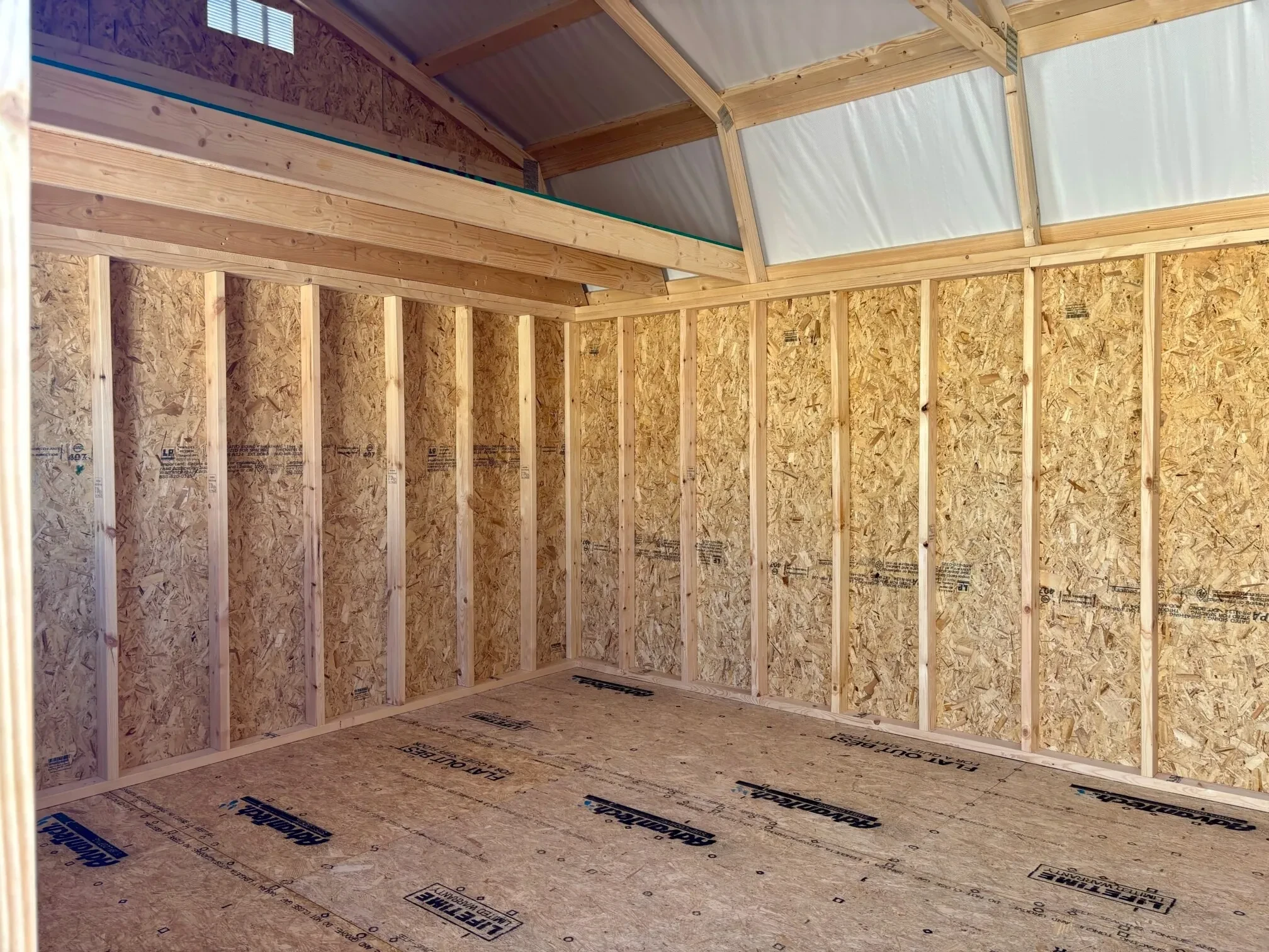 the interior of a lofted barn with astro armor under the roof and a loft on the end