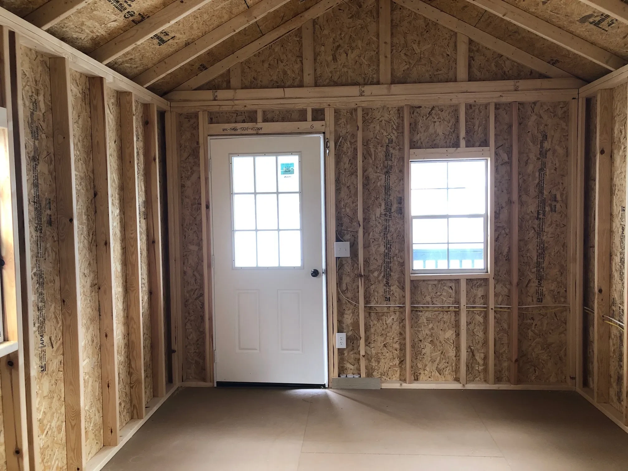 inside a cabin looking at the 9-lite walk in door and the window next to it