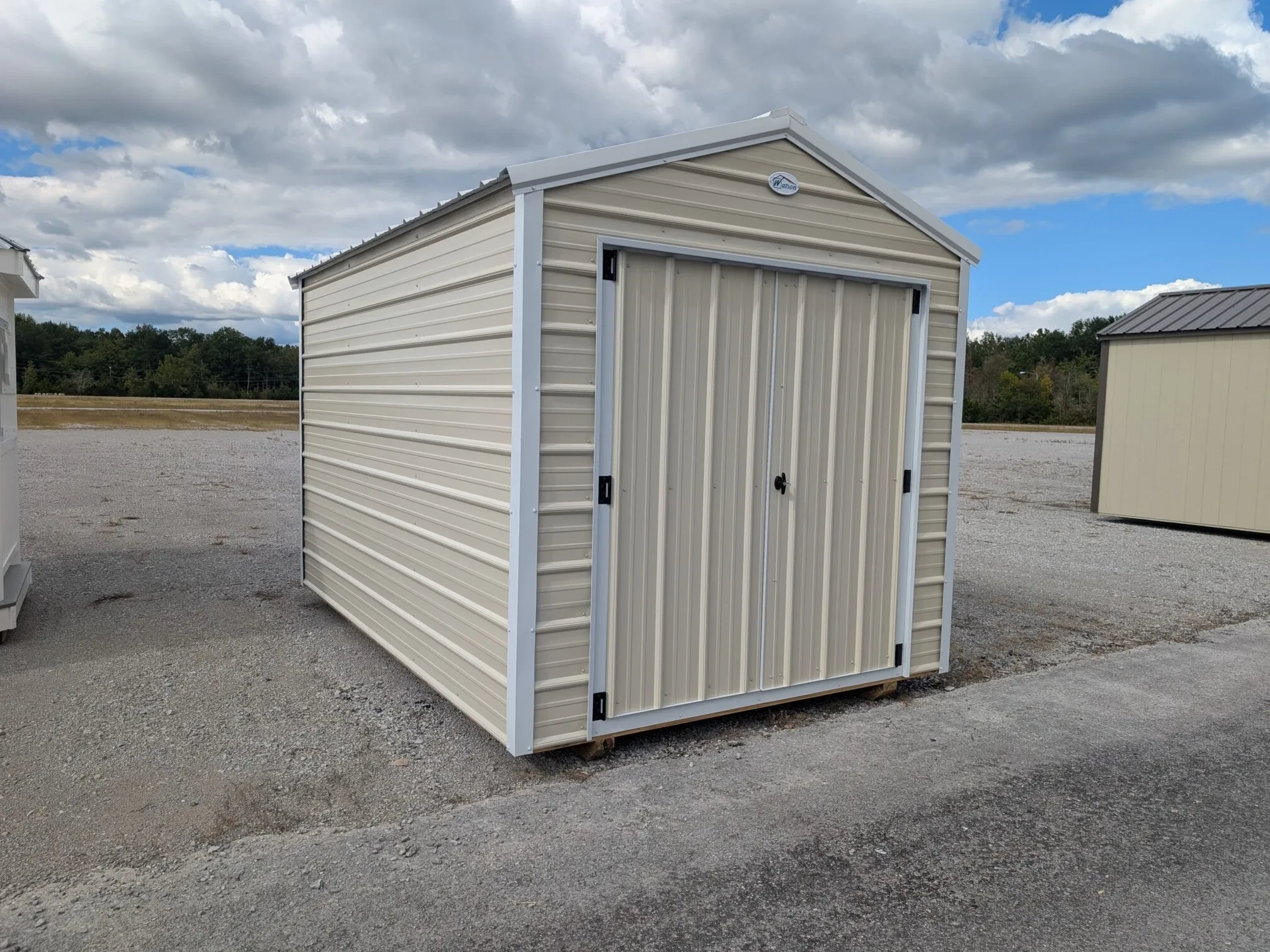 an 8x12 metal shed colored light stone with white trim