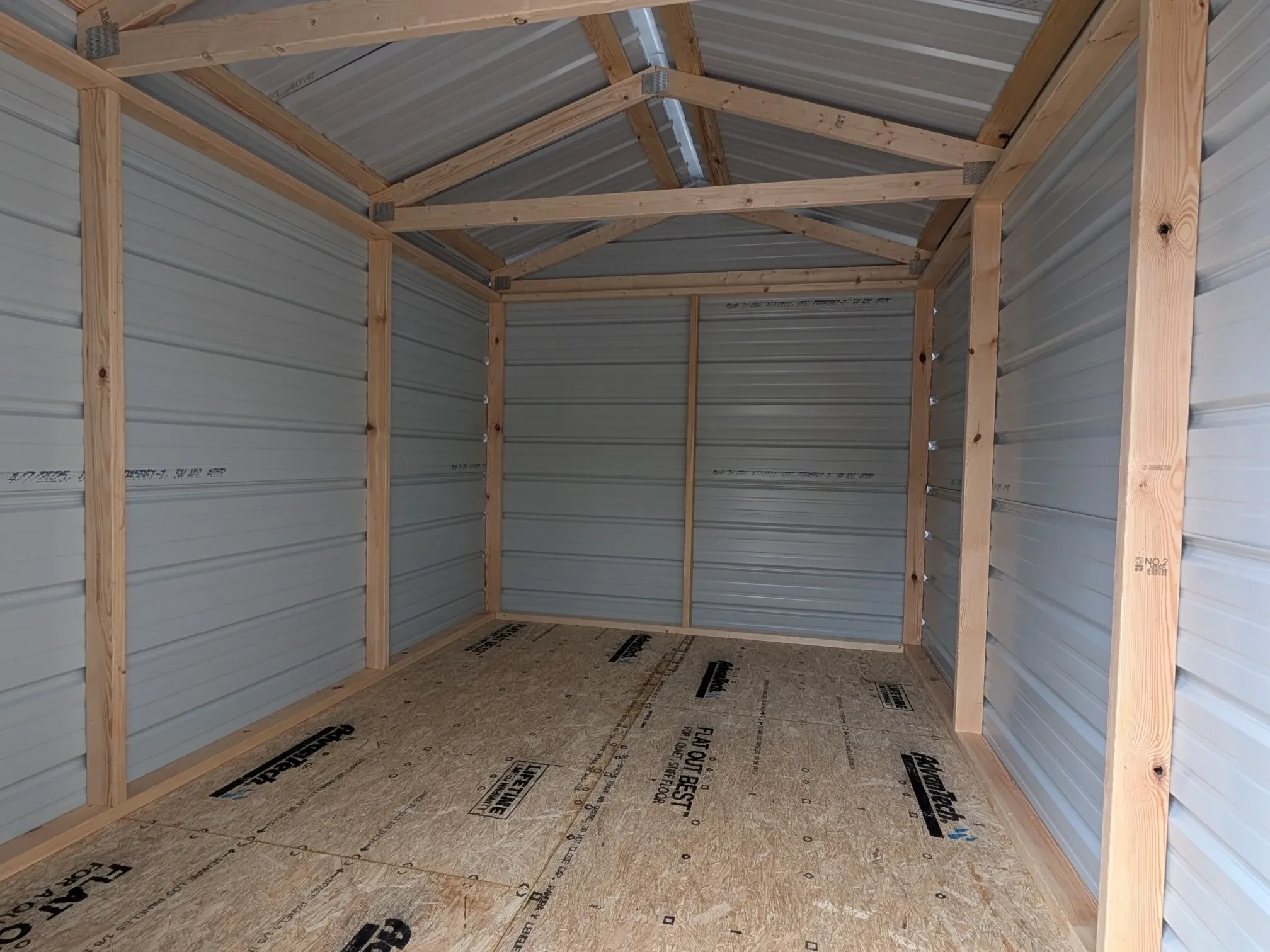 inside a metal shed showing the framing and floor