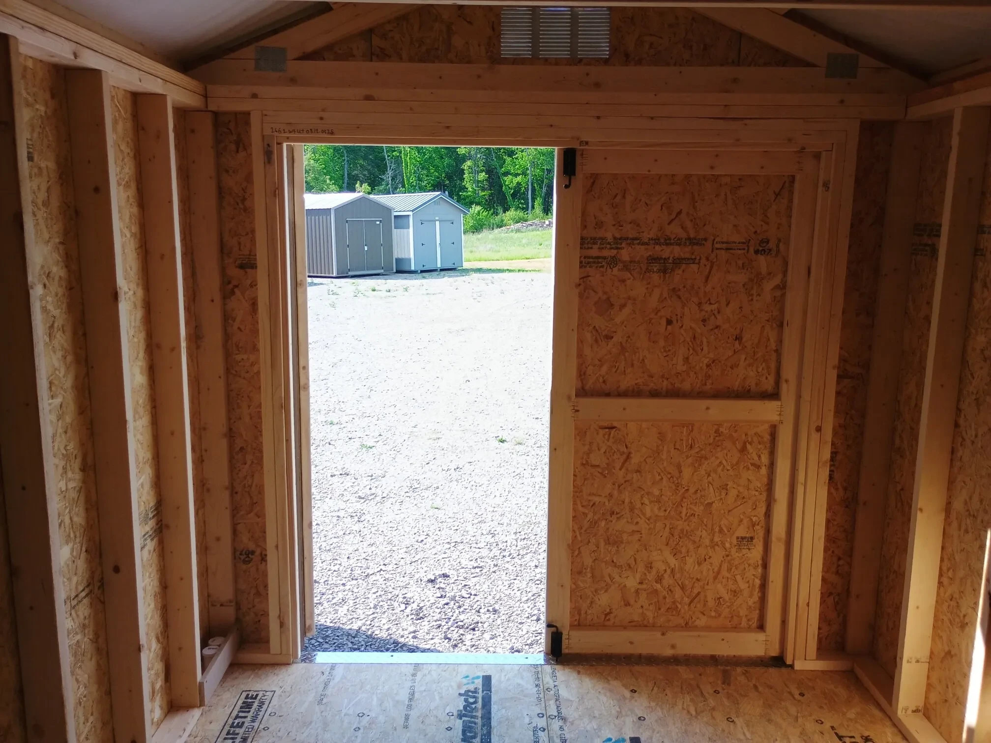 looking through the double doors of a small wood shed