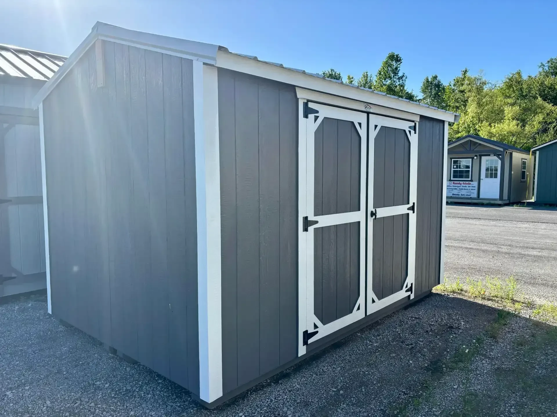 a charcoal colored wood shed with double doors