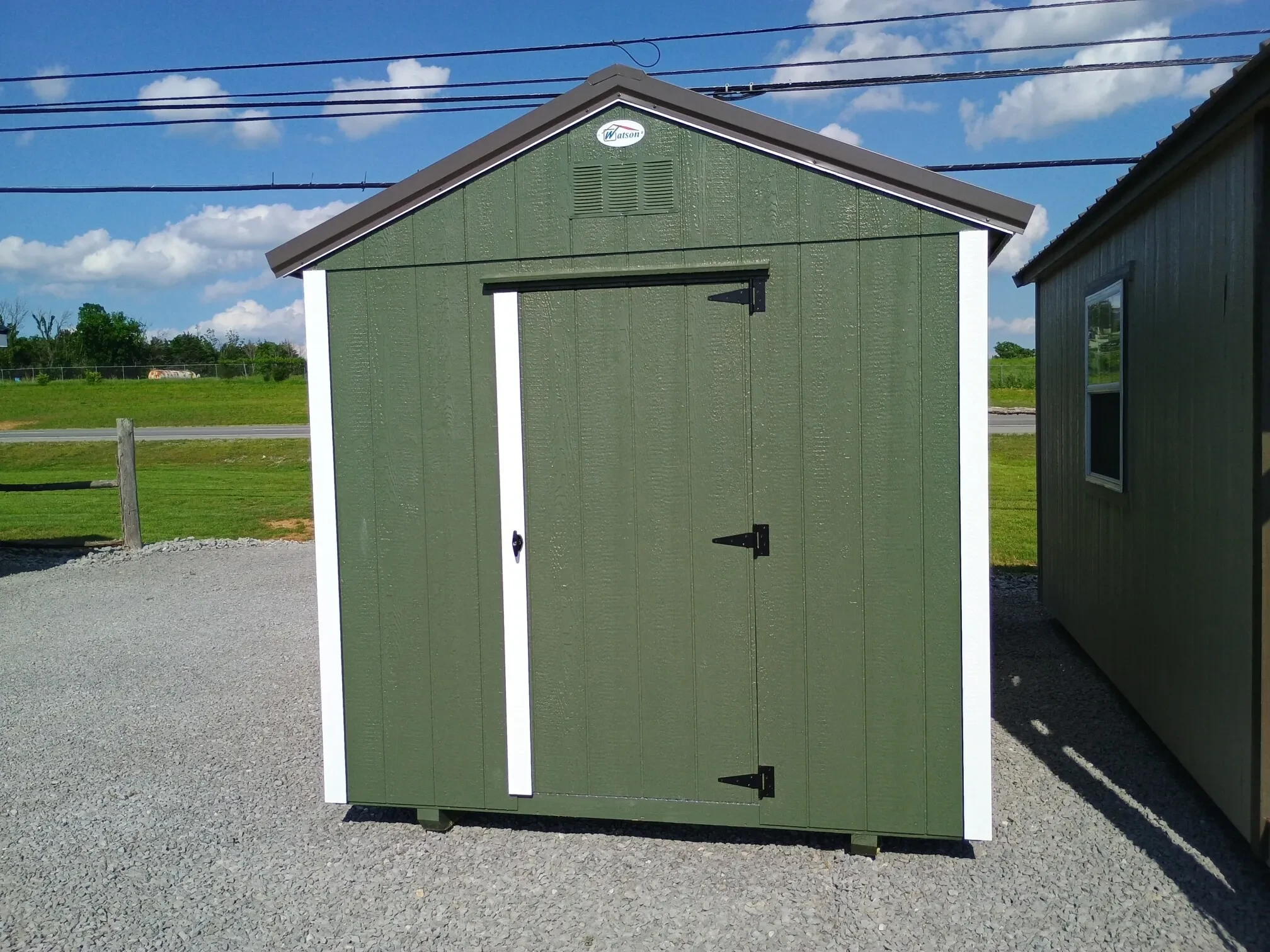 the back of a green dog kennel showing a 30" walk-in door