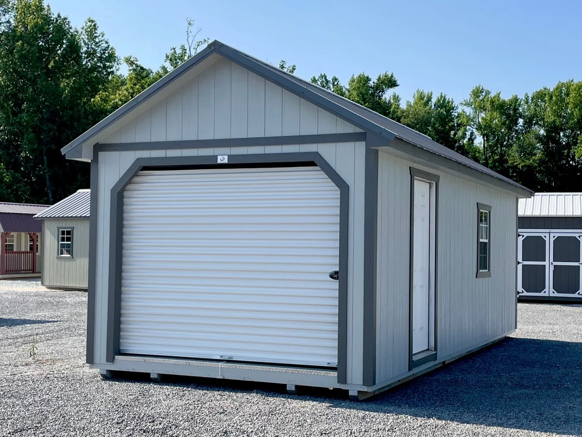 a premium wood shed with a garage door in the end and a solid panel walk-in door and window in the side