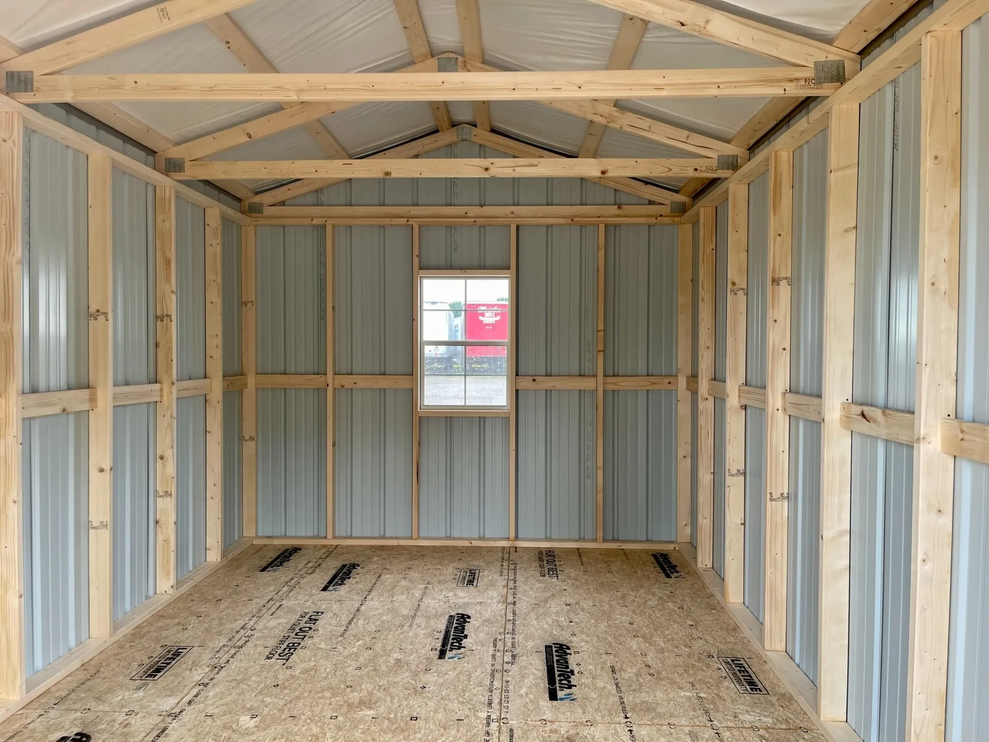 a window along the back wall inside a metal shed
