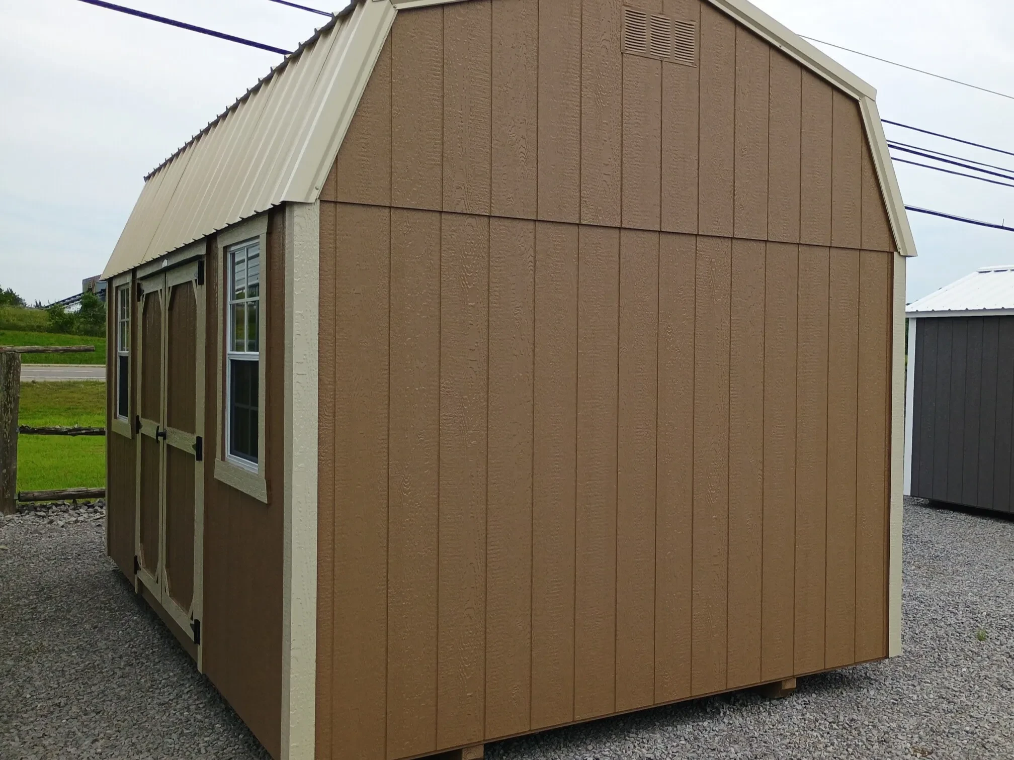 a pine bark colored side lofted barn with double doors and two 2x3 windows