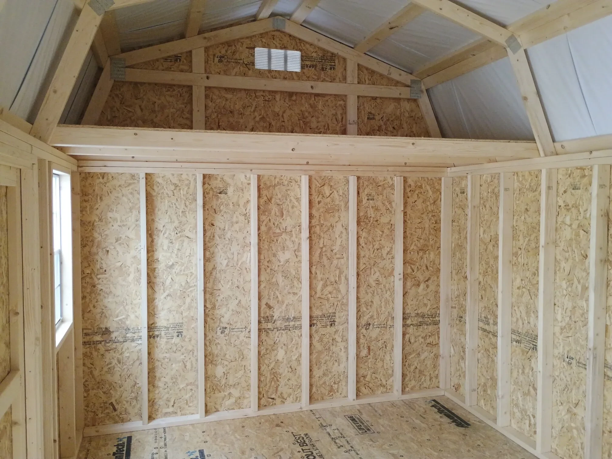 a loft and a window inside a lofted barn