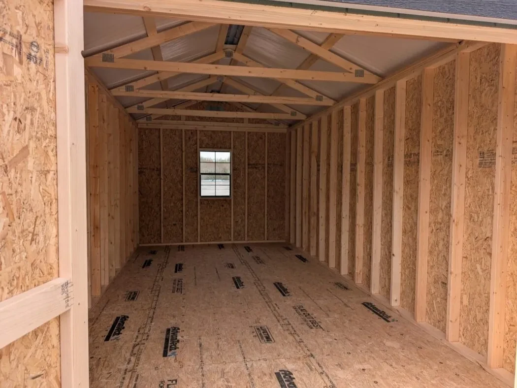 inside a 10x20 wood shed with a window in the middle of the back wall