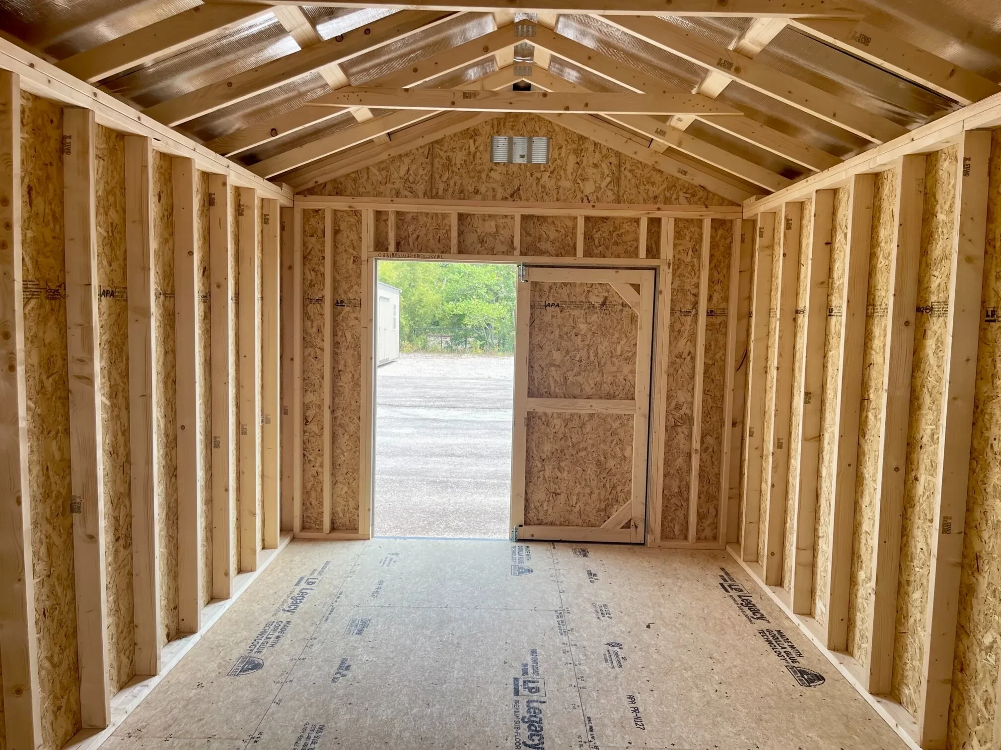 inside a wood shed looking through the open double doors