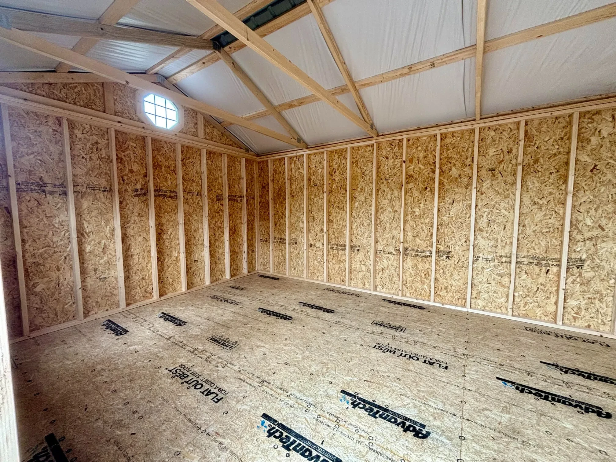 interior of a garden shed with an octagon window near the peak