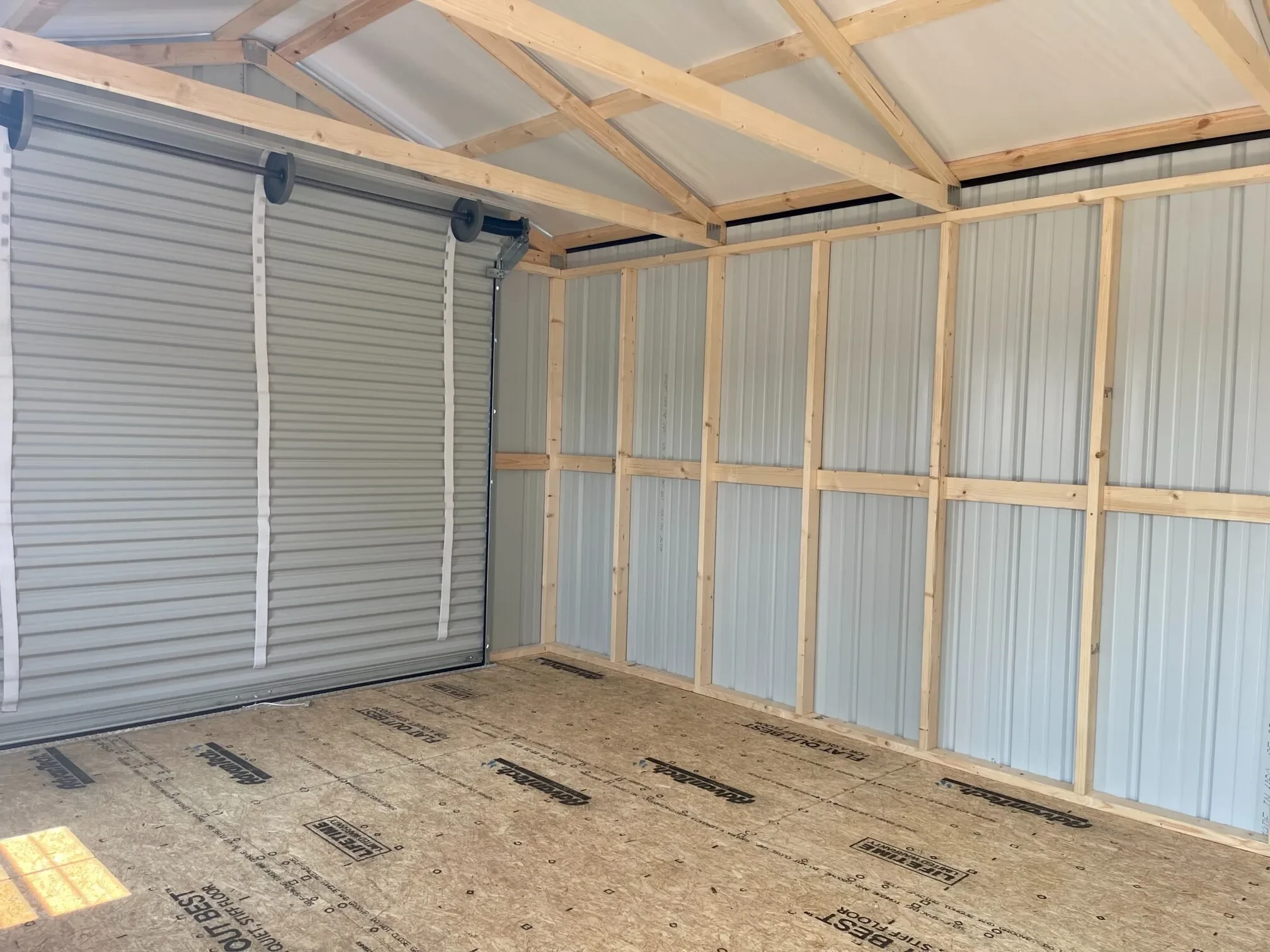 looking at the back of an 8x7 rollup door from the inside of a metal garage shed