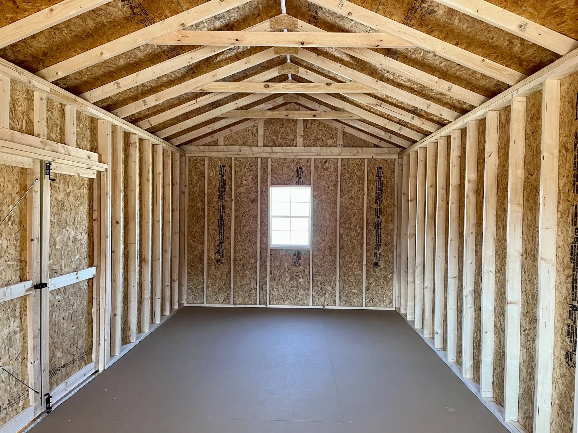 looking at a window in the middle of the back wall from inside a wood cabin