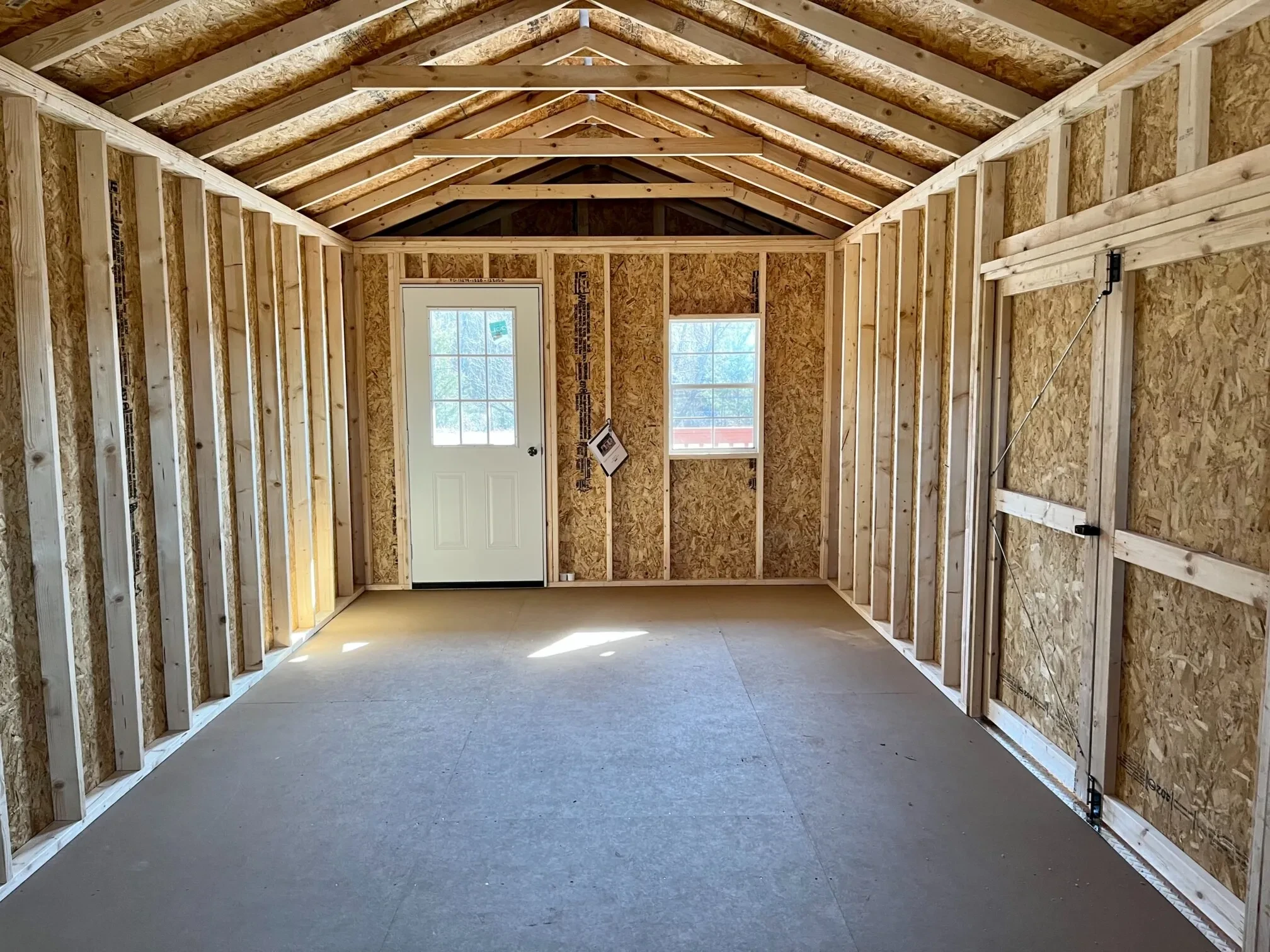 looking at a 9-lite walk-in door next to a 2x3 from the inside of a wood cabin