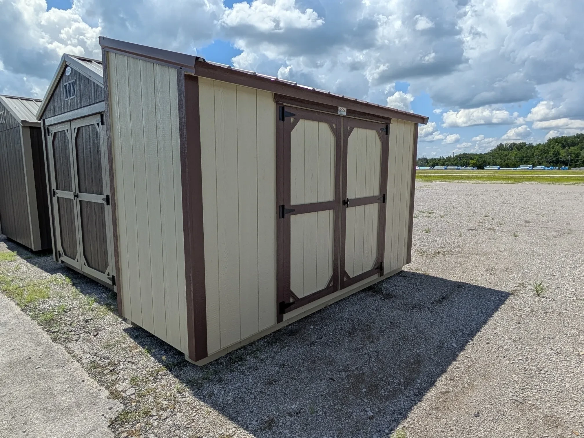 a wood leanto style shed with 72" double doors