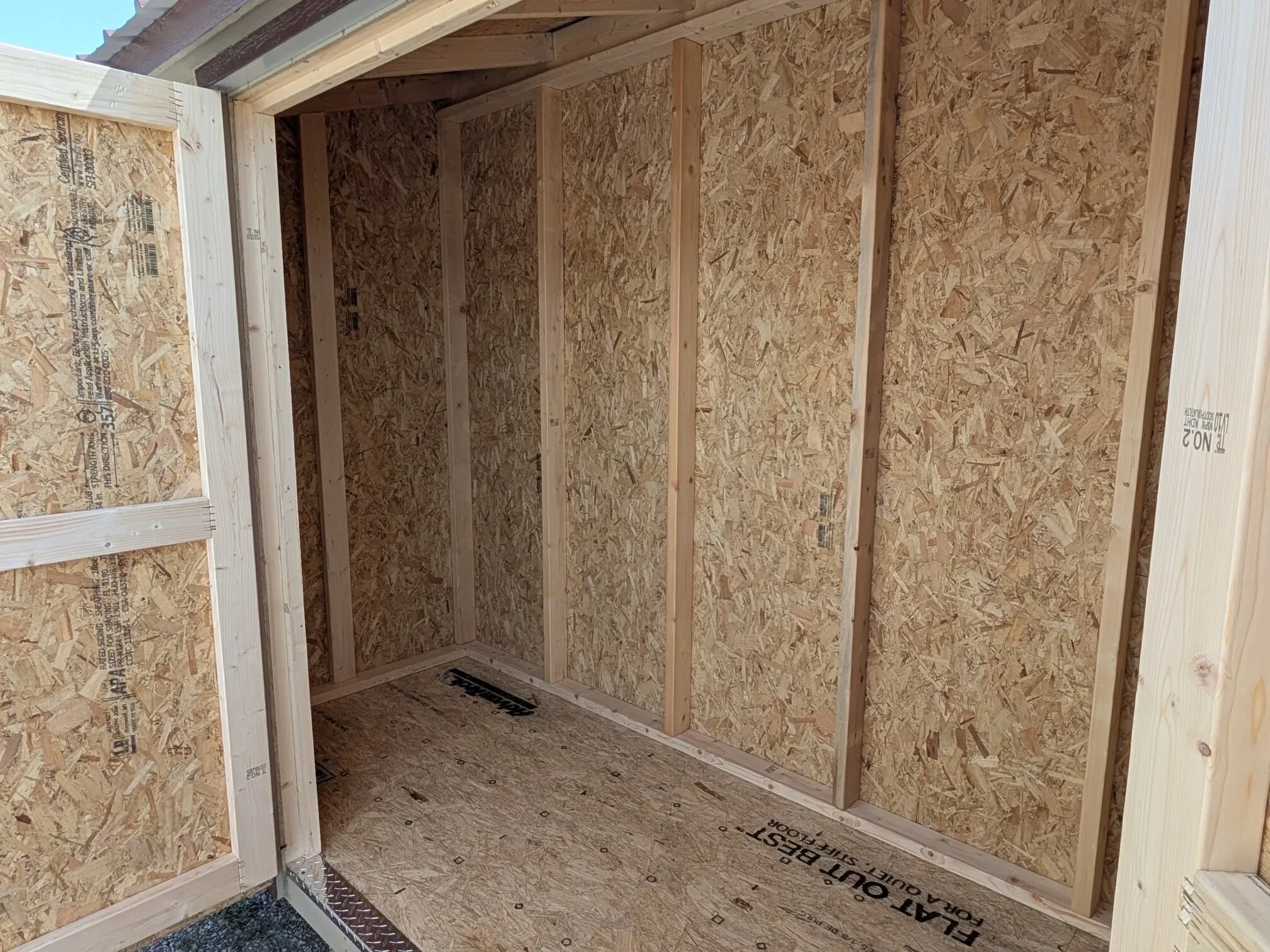 looking inside a small leanto style wood shed