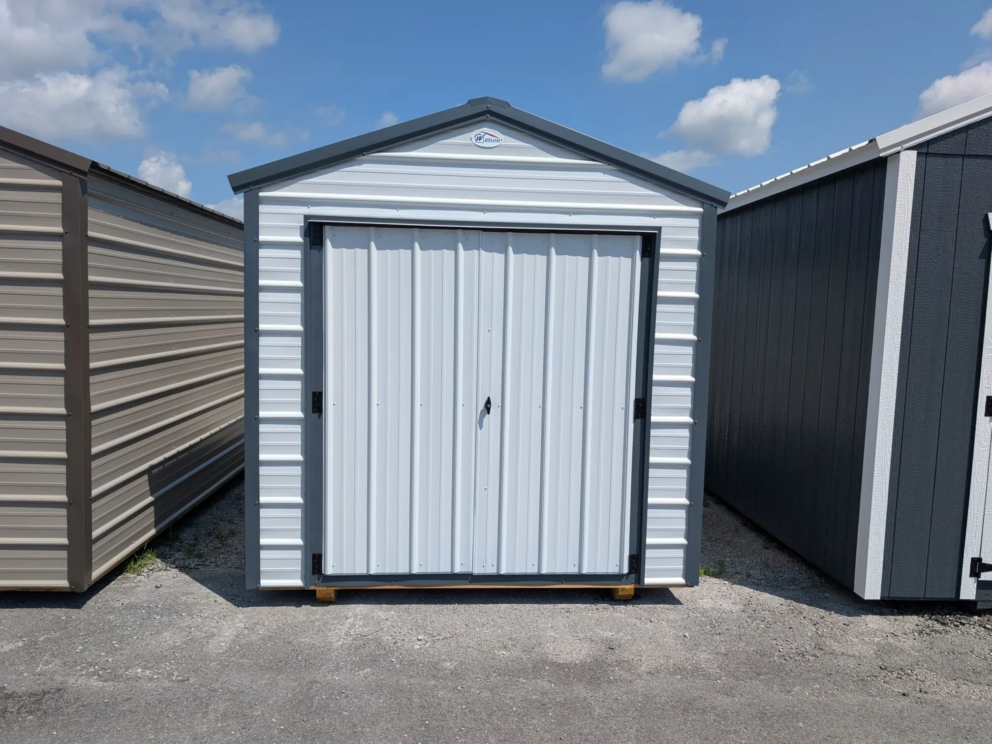 a white metal shed with 66" double doors