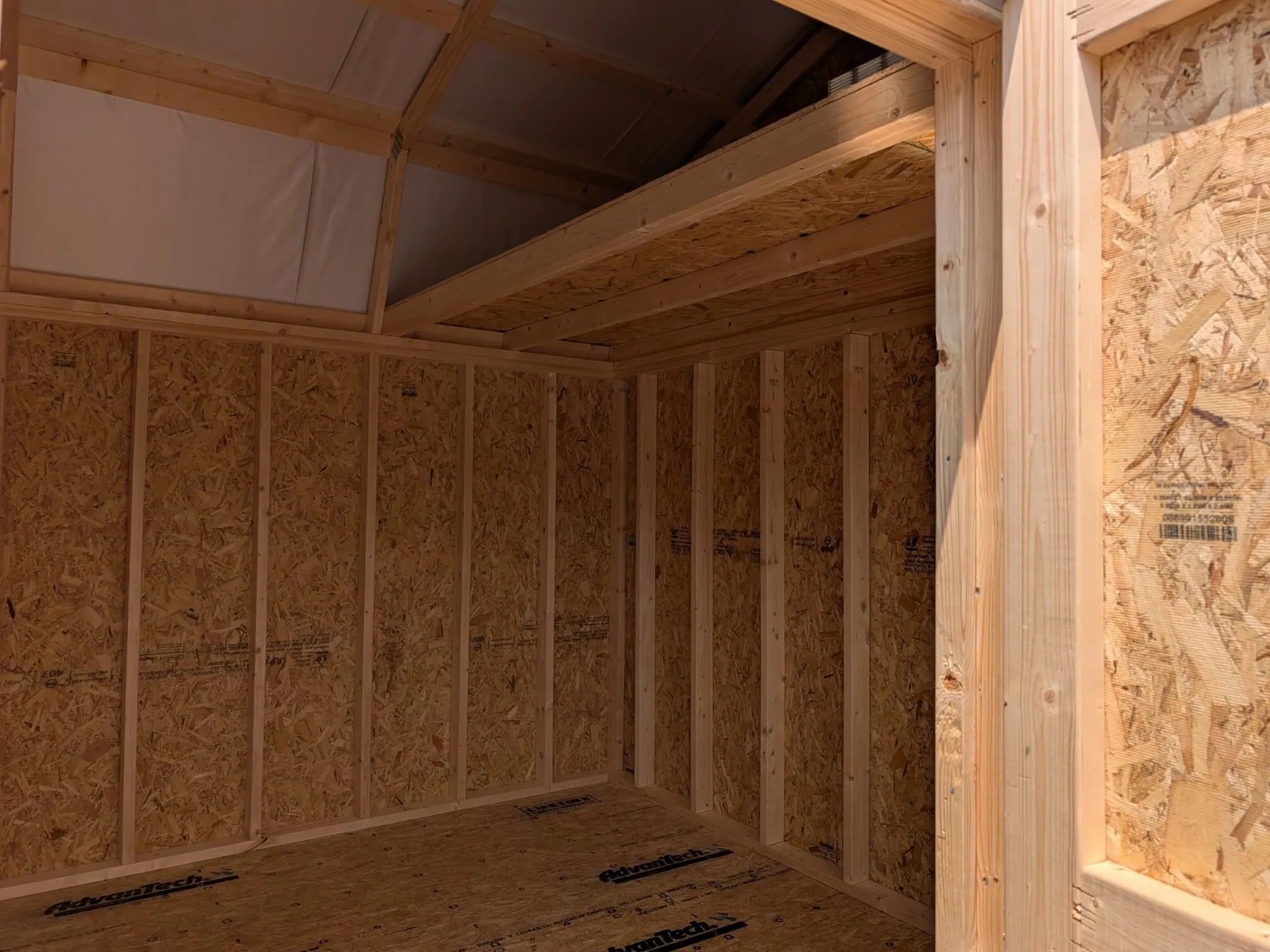 looking into a wood side lofted barn up at the loft on the right side