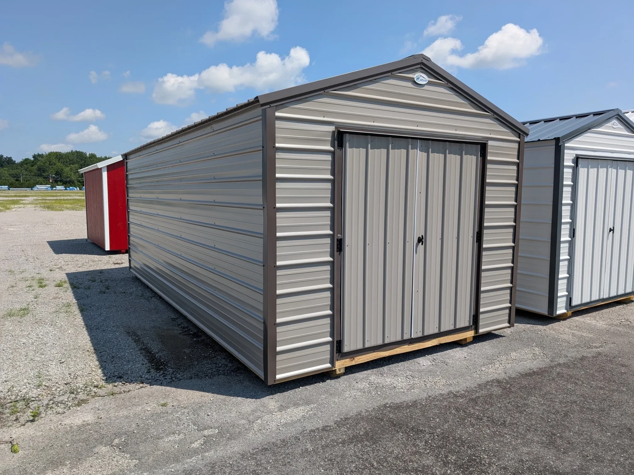a large storage shed made out of metal and it has double doors