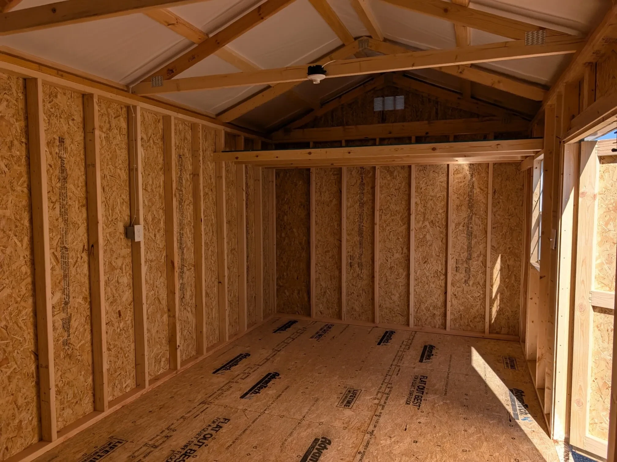 inside a wood garden with a loft on the right side