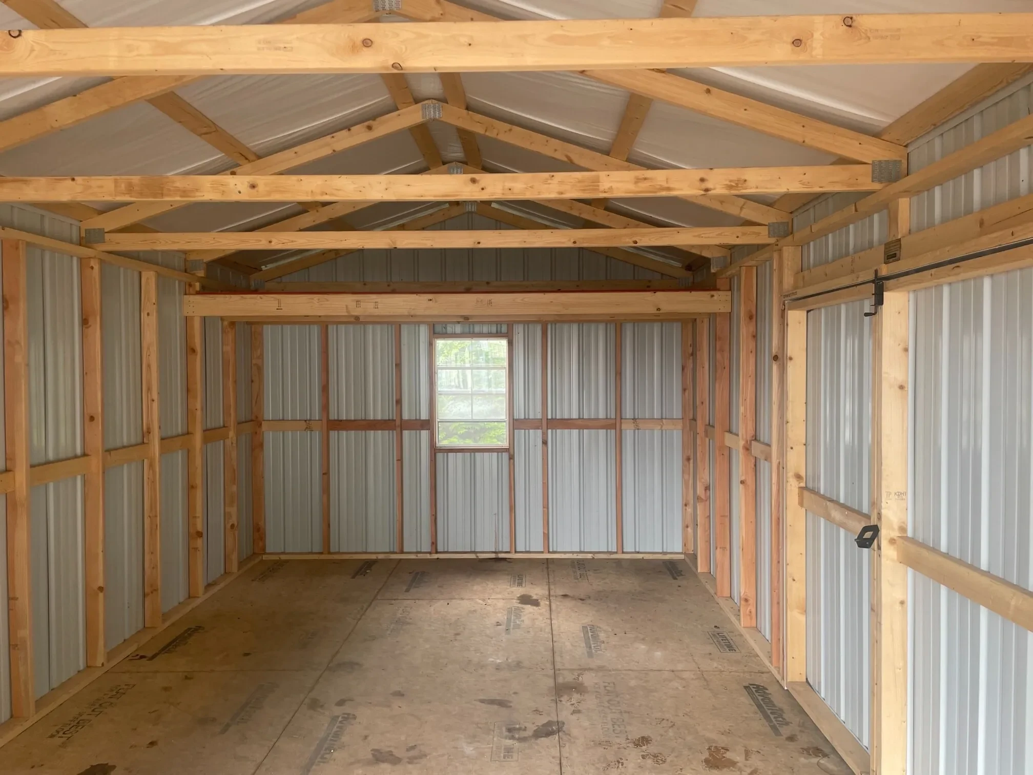 inside a metal garage with a window on the back wall