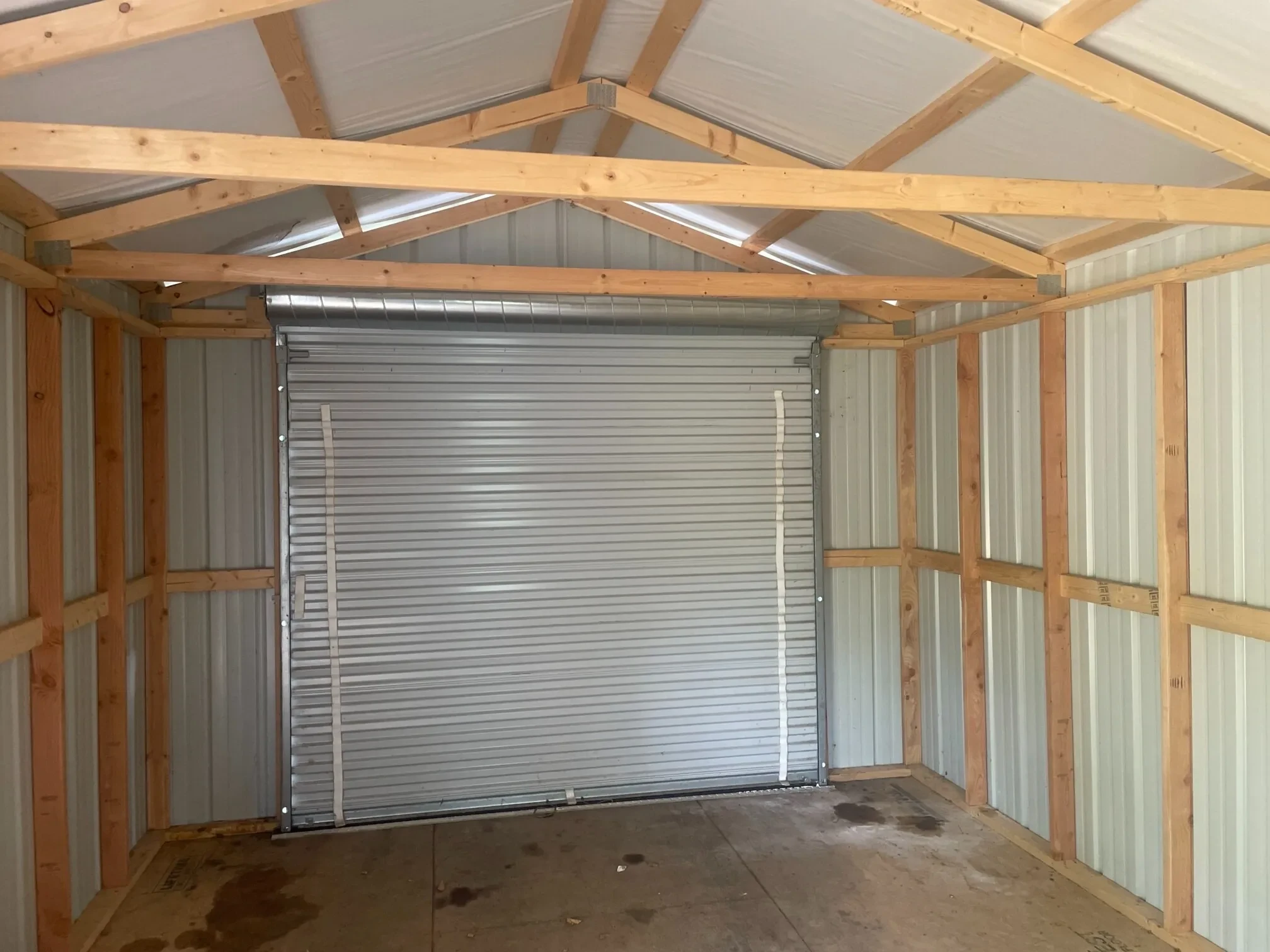 an 8x7 rollup door from inside a metal garage shed