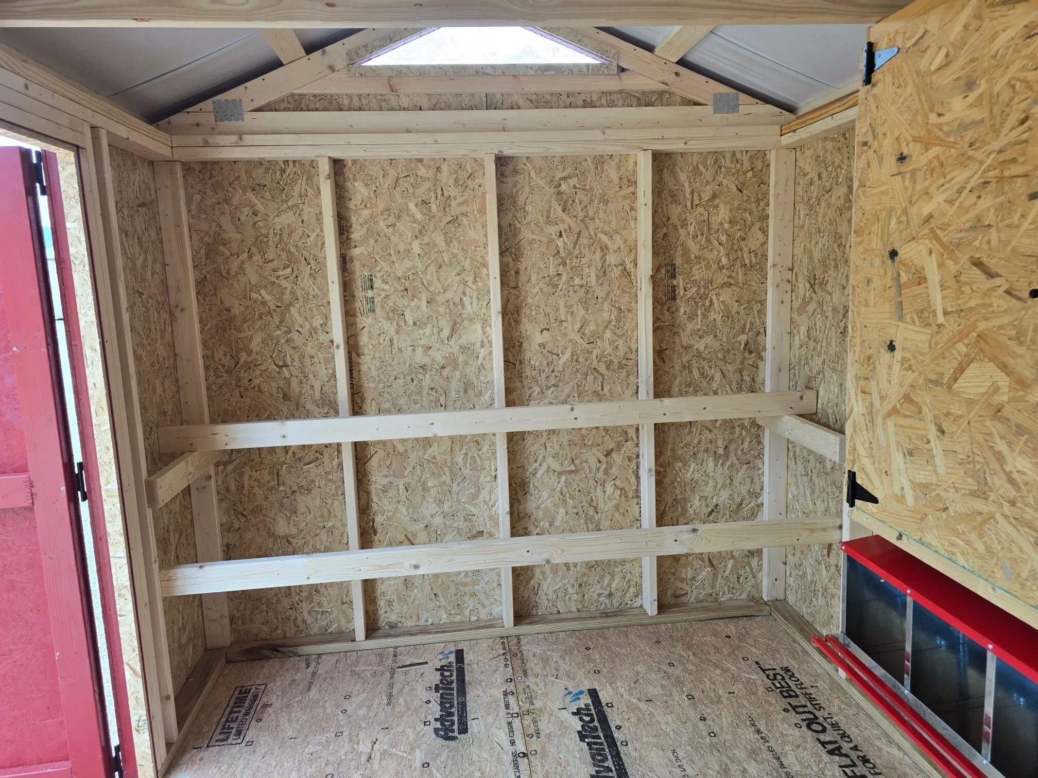 two roosting bars for chickens inside a chicken coop