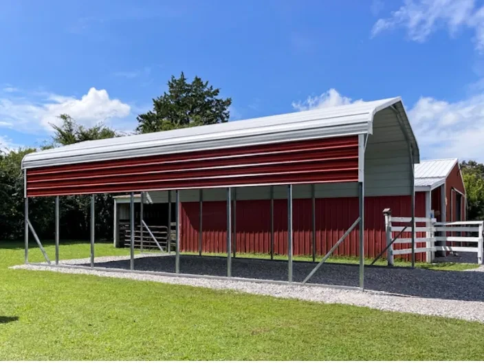 A tall and long RV cover with a white roof and red side panels