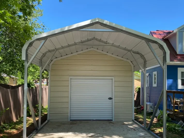 a stone rounded frame carport with an enclosed shed portion