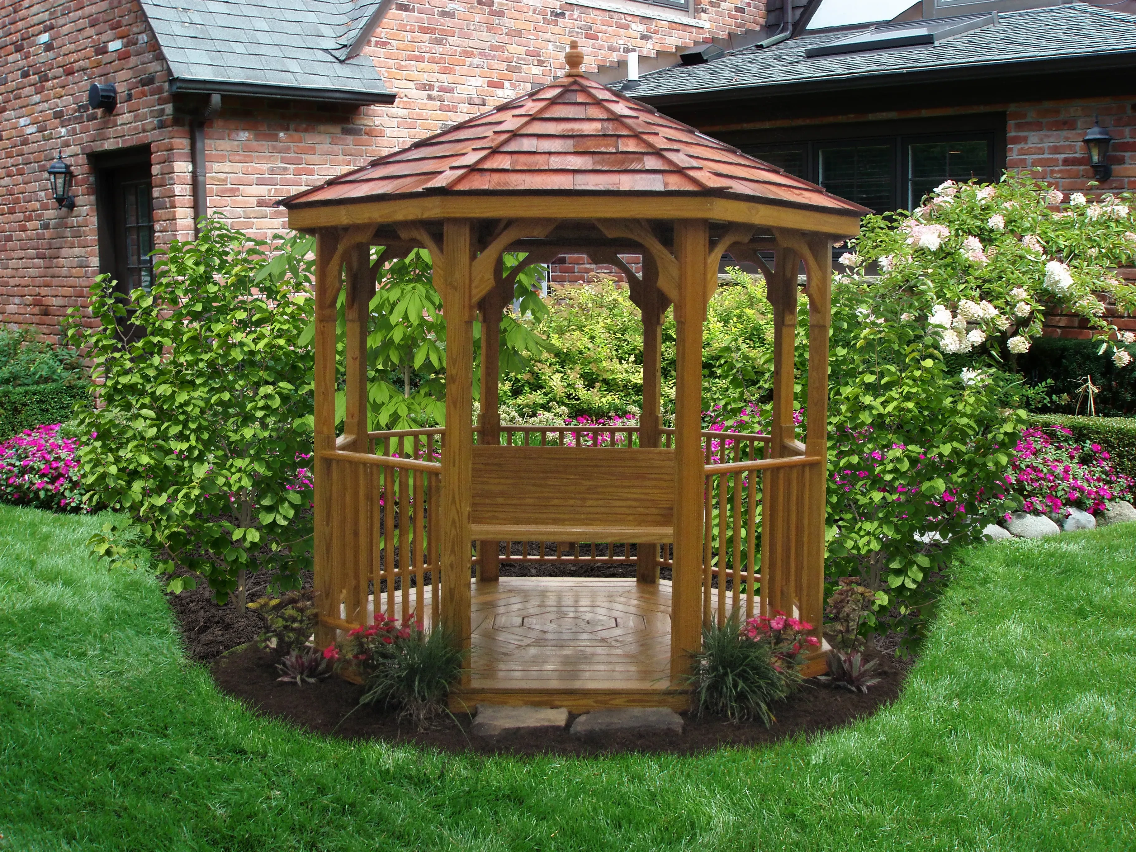 A small value wood gazebo in a landscaped backyard