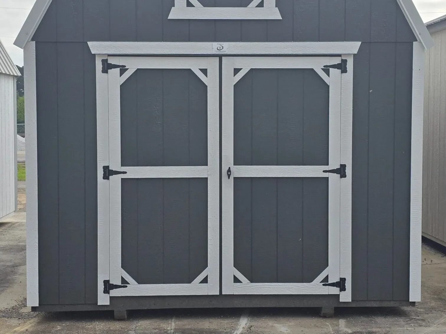 the front of a woof lofted barn that is painted burnished slate