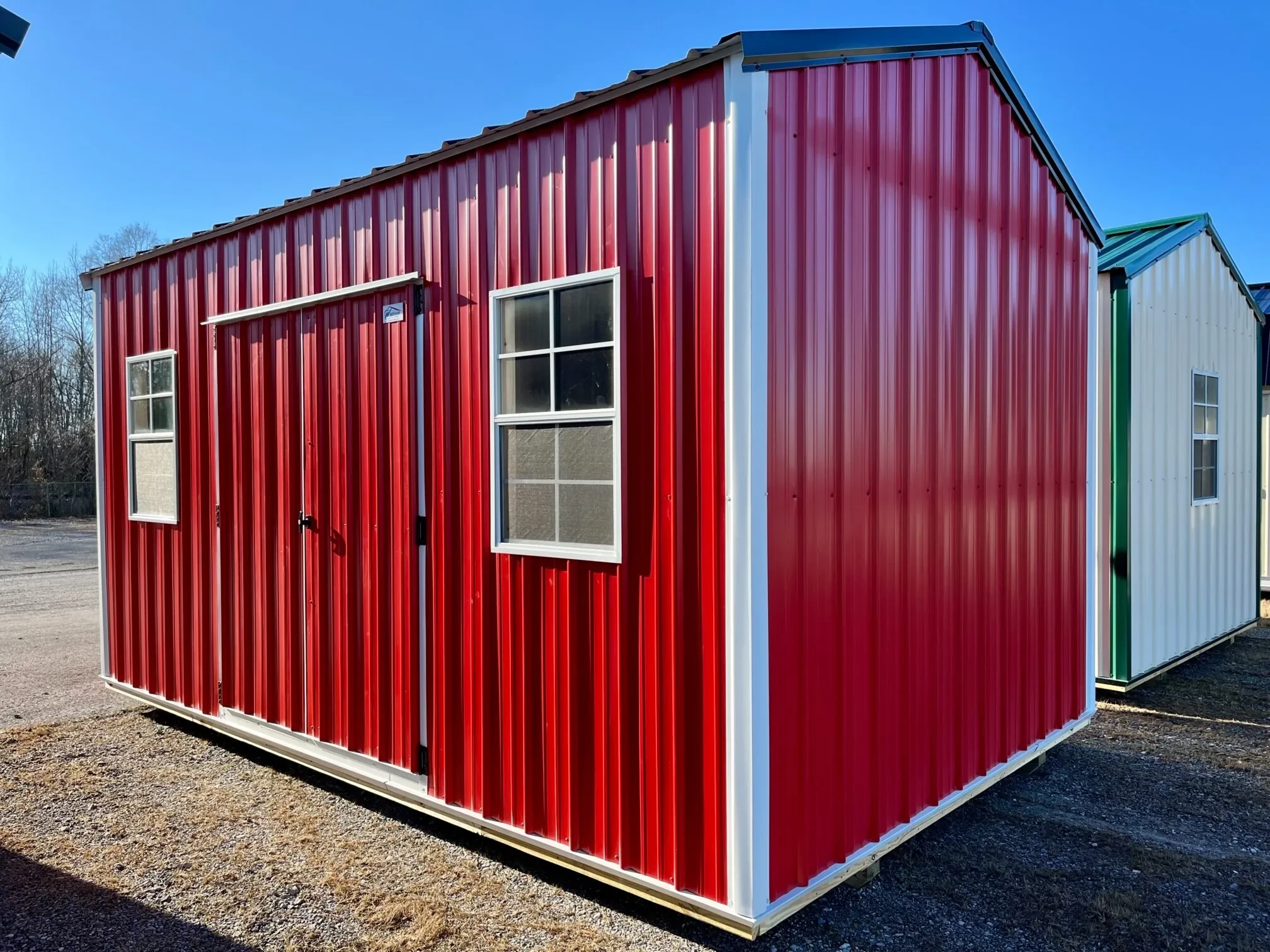 a red metal garden shed with 66" double doors and two 2x3 windows