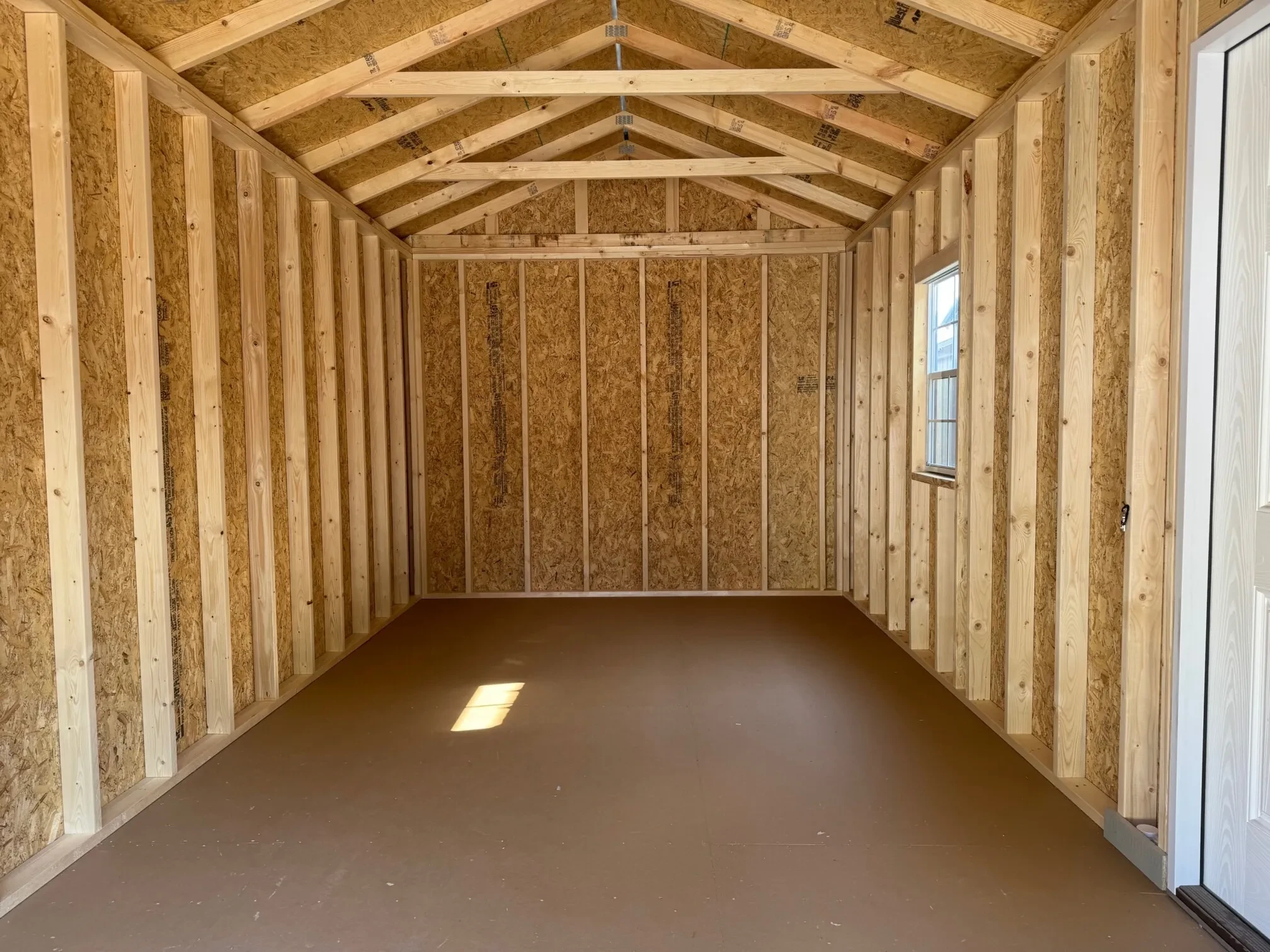 inside a garage shed with a window on the right wall