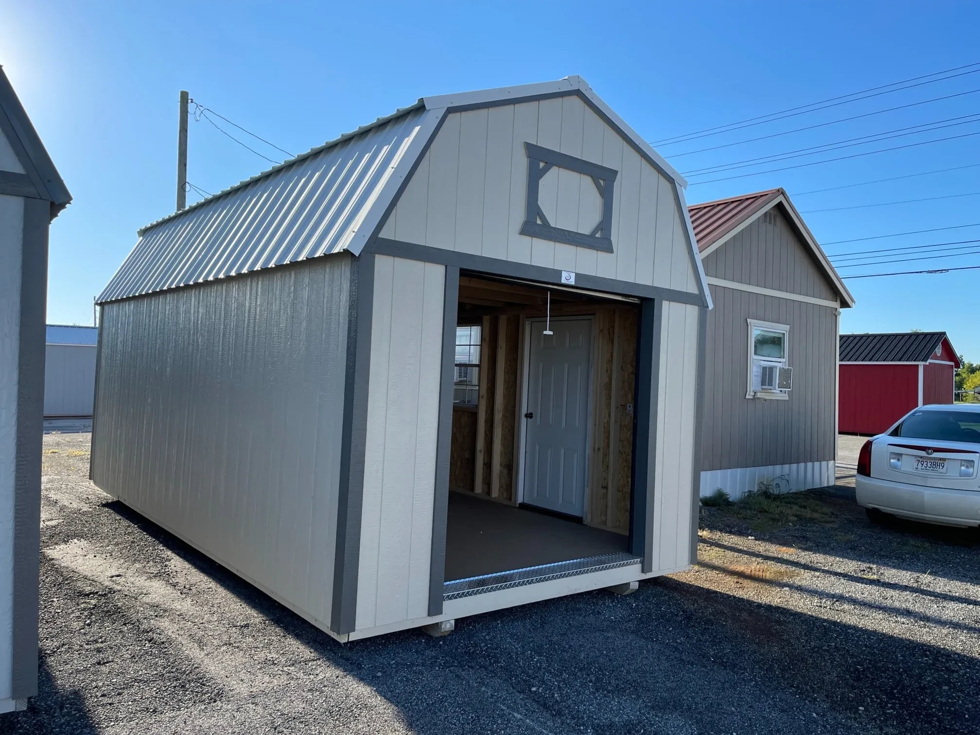 a wood lofted garage with the 6x7 rollup door open