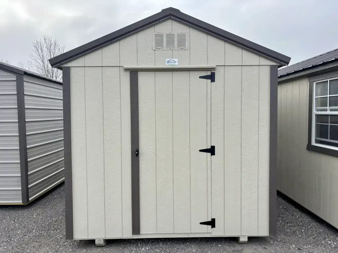 the back side of a wood dog kennel which has a 30" walk-in door