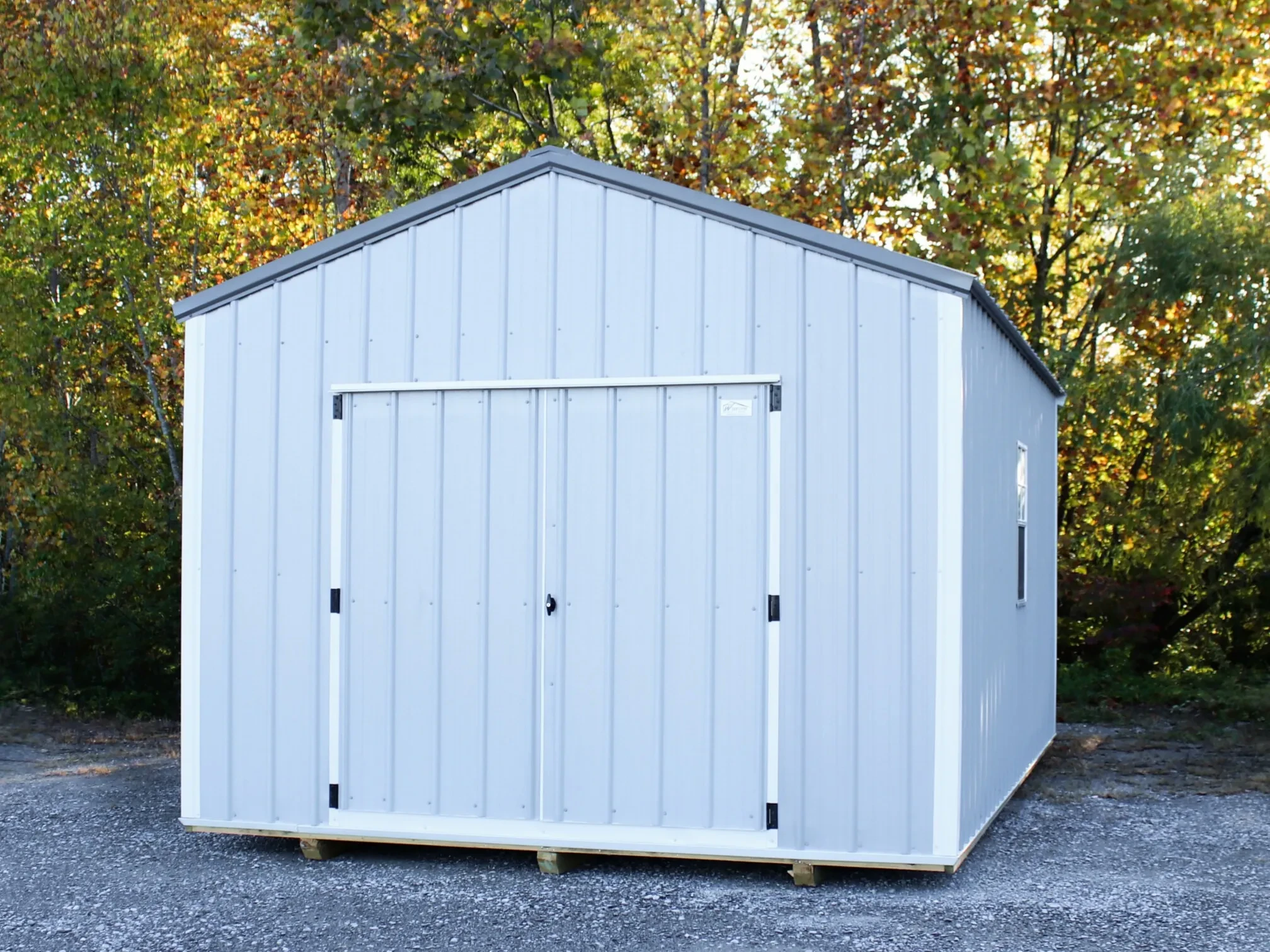 a basic metal shed with double doors in the front and a window in the side