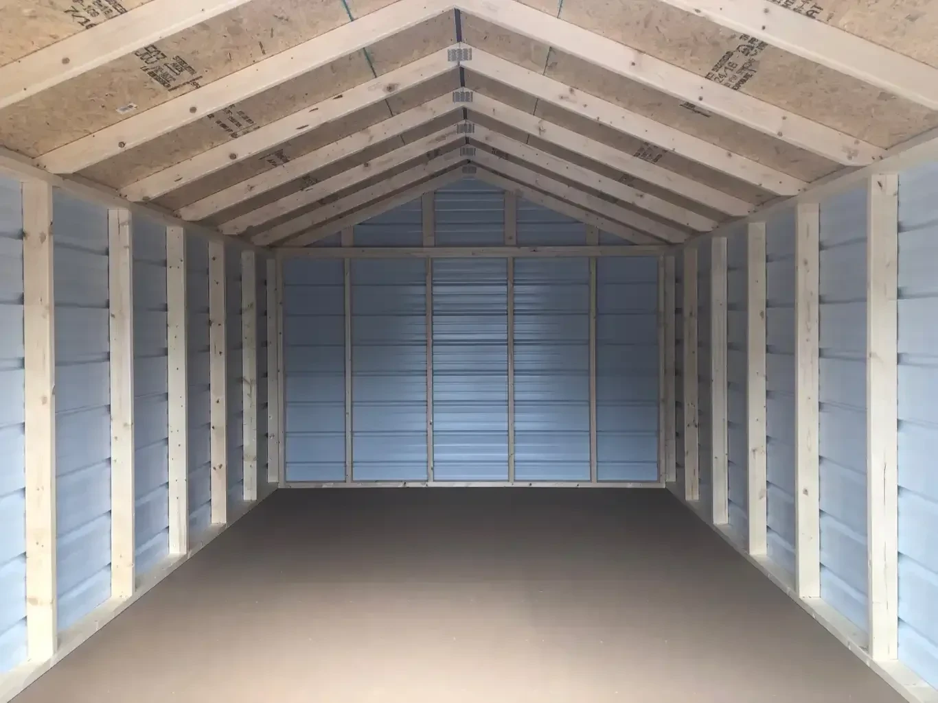 inside a metal utility shed that shows the framing and the solid floor