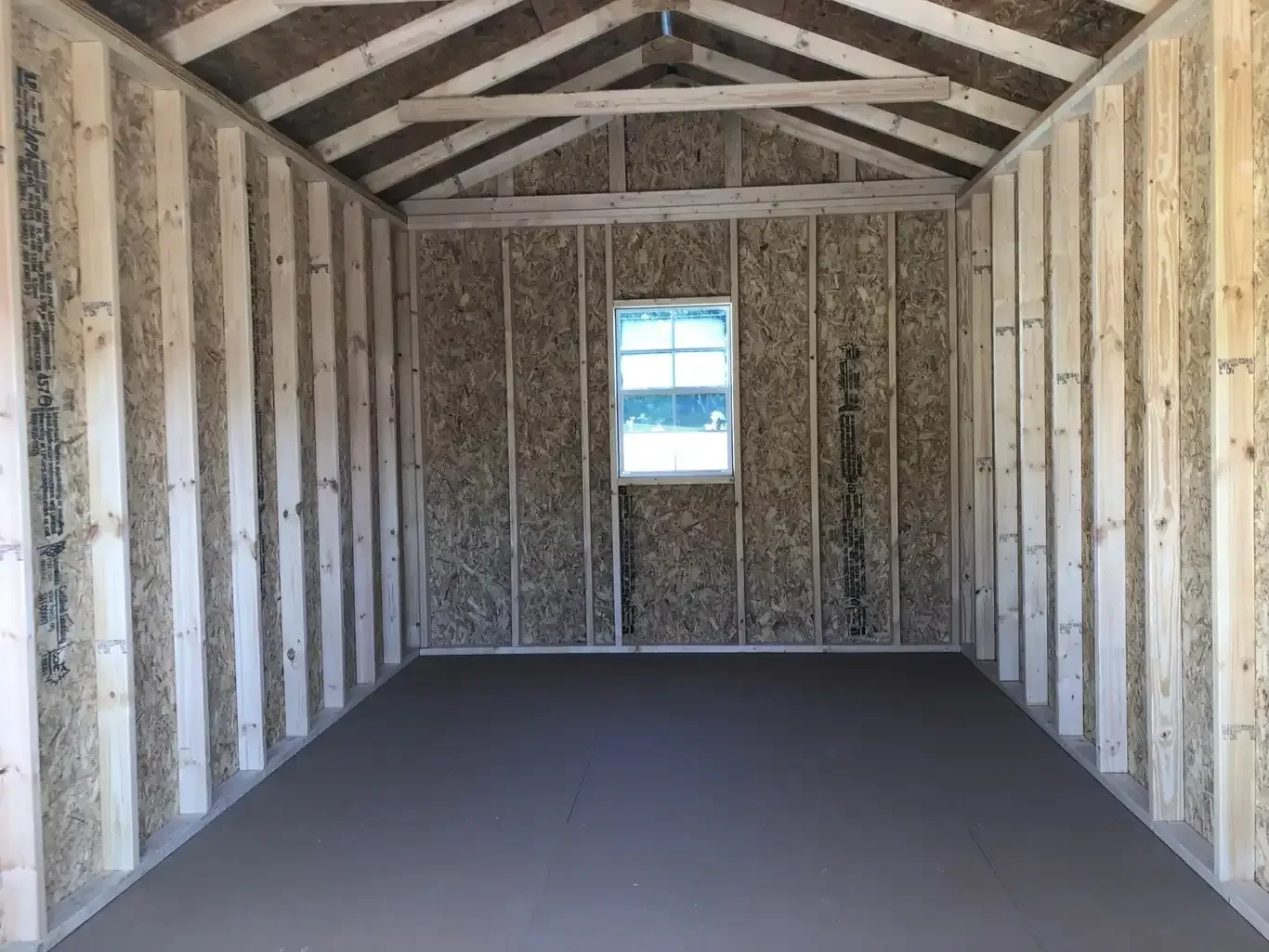 a 2x3 window along the back wall of a wood utility shed