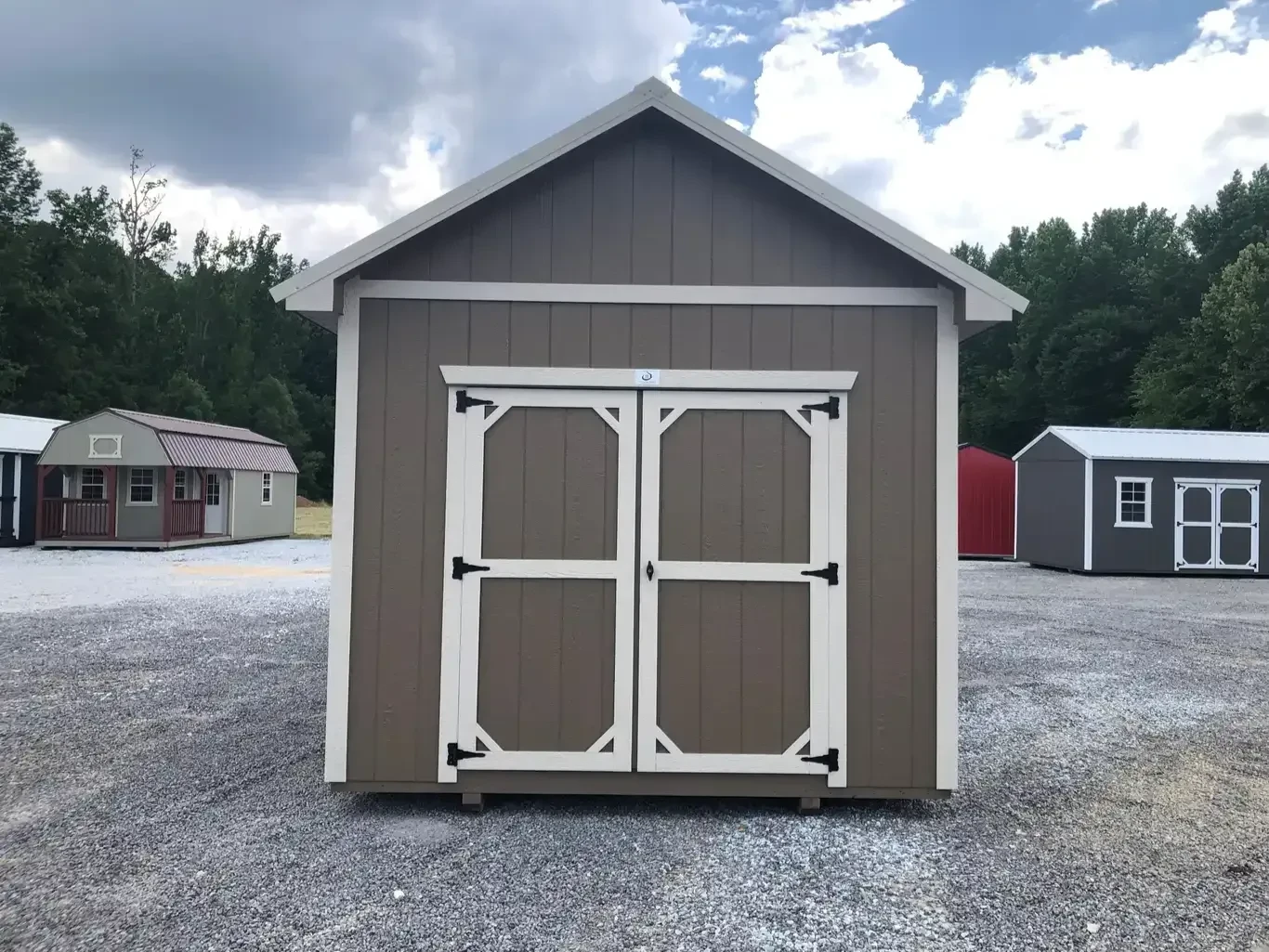 a pine bark colored utility shed with double doors and a roof overhang on all sides
